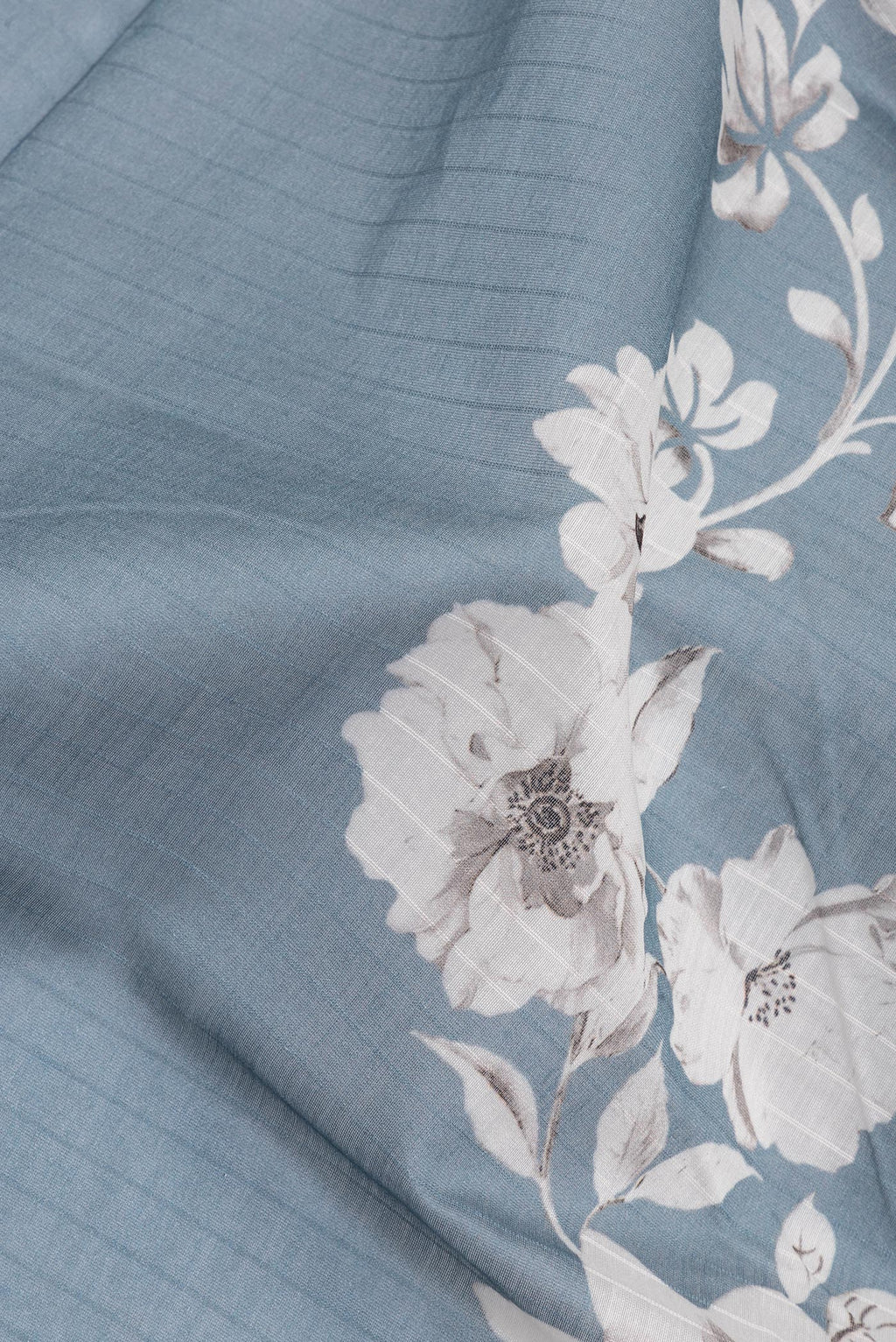 Close up of Pure Silk Grey Dual Tone Chanderi Saree with Printed design on the body and Zari And Thread Border.  displaying folds