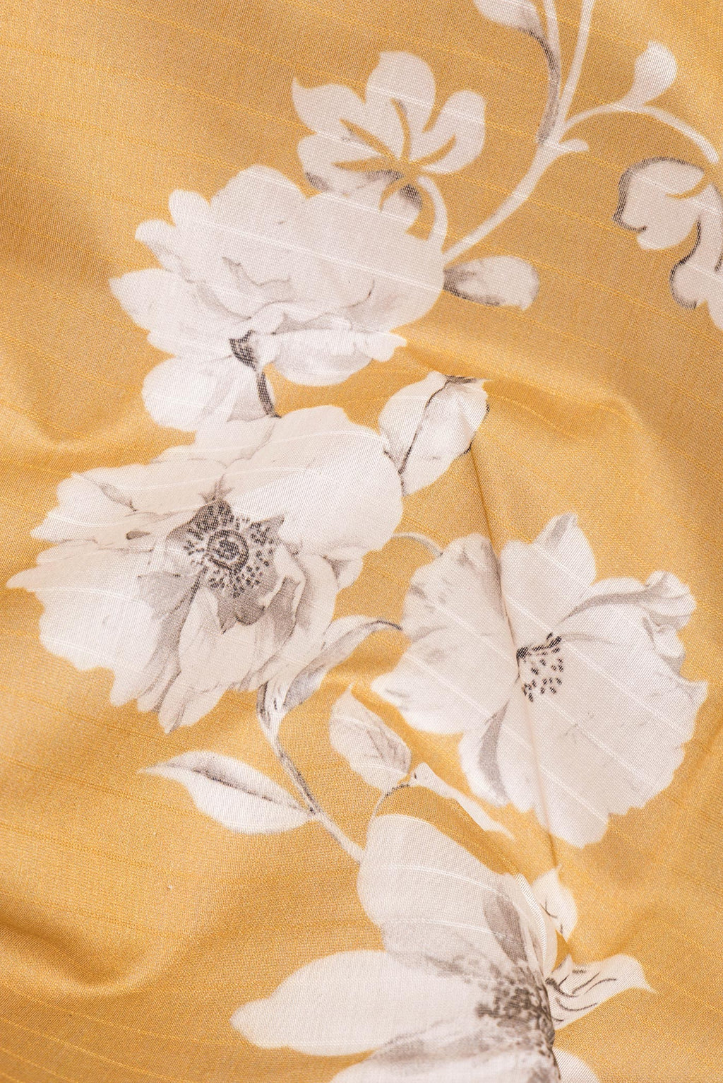 Close up of Pure Silk Mustard Dual Tone Chanderi Saree with Printed design on the body and Zari And Thread Border.  displaying folds