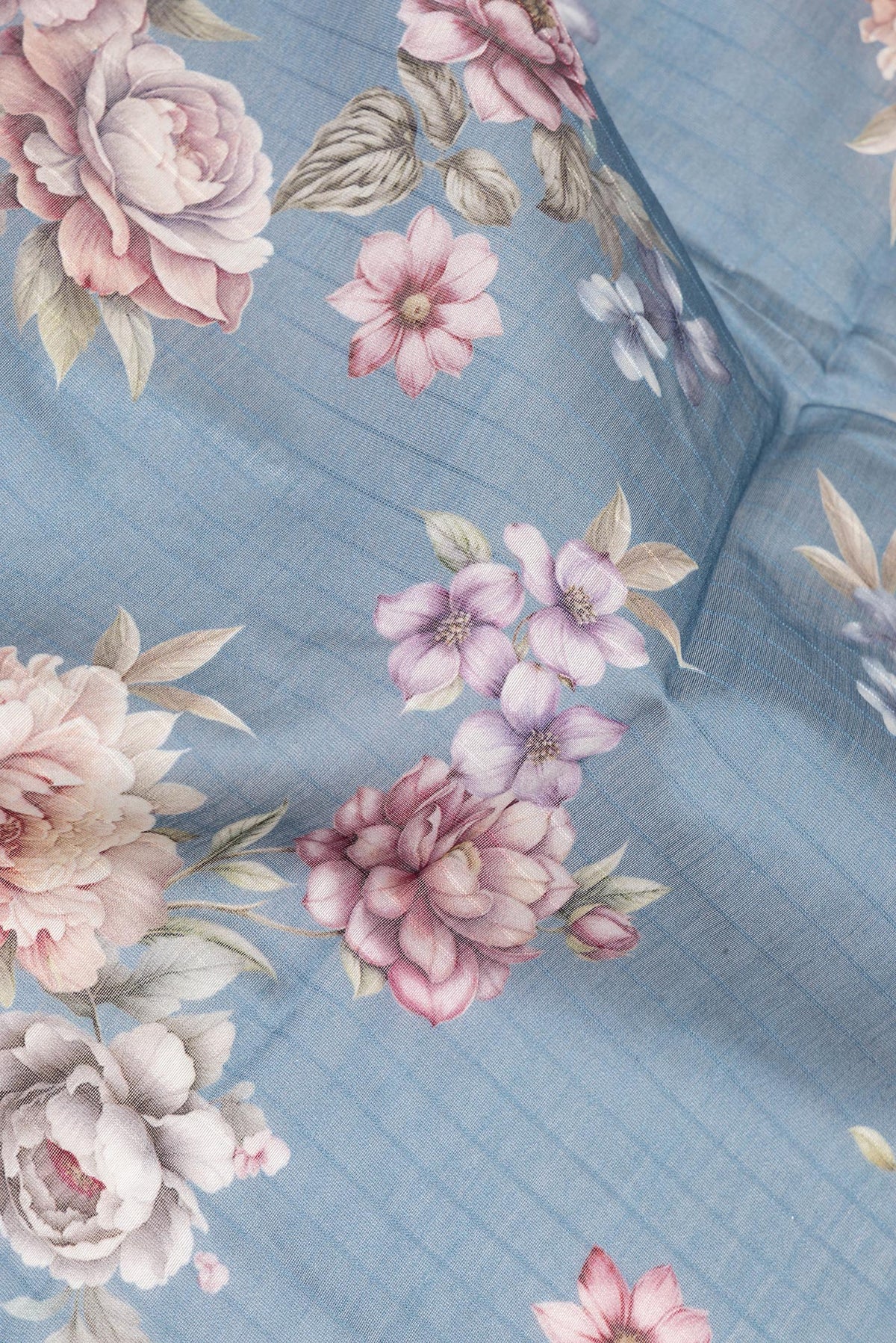 Close up of Light Blue Chanderi Cotton Saree with Floral Print on the body and Zari And Thread Border.  displaying folds