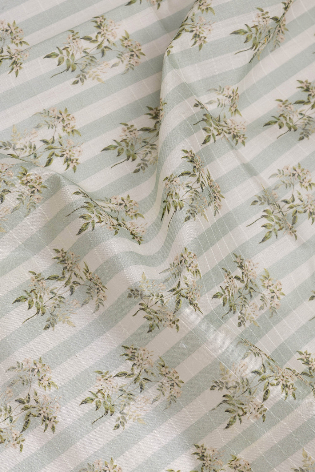 Close up of Green Dual Tone Chanderi Silk Saree with Printed design on the body and Zari And Thread Border.  displaying folds