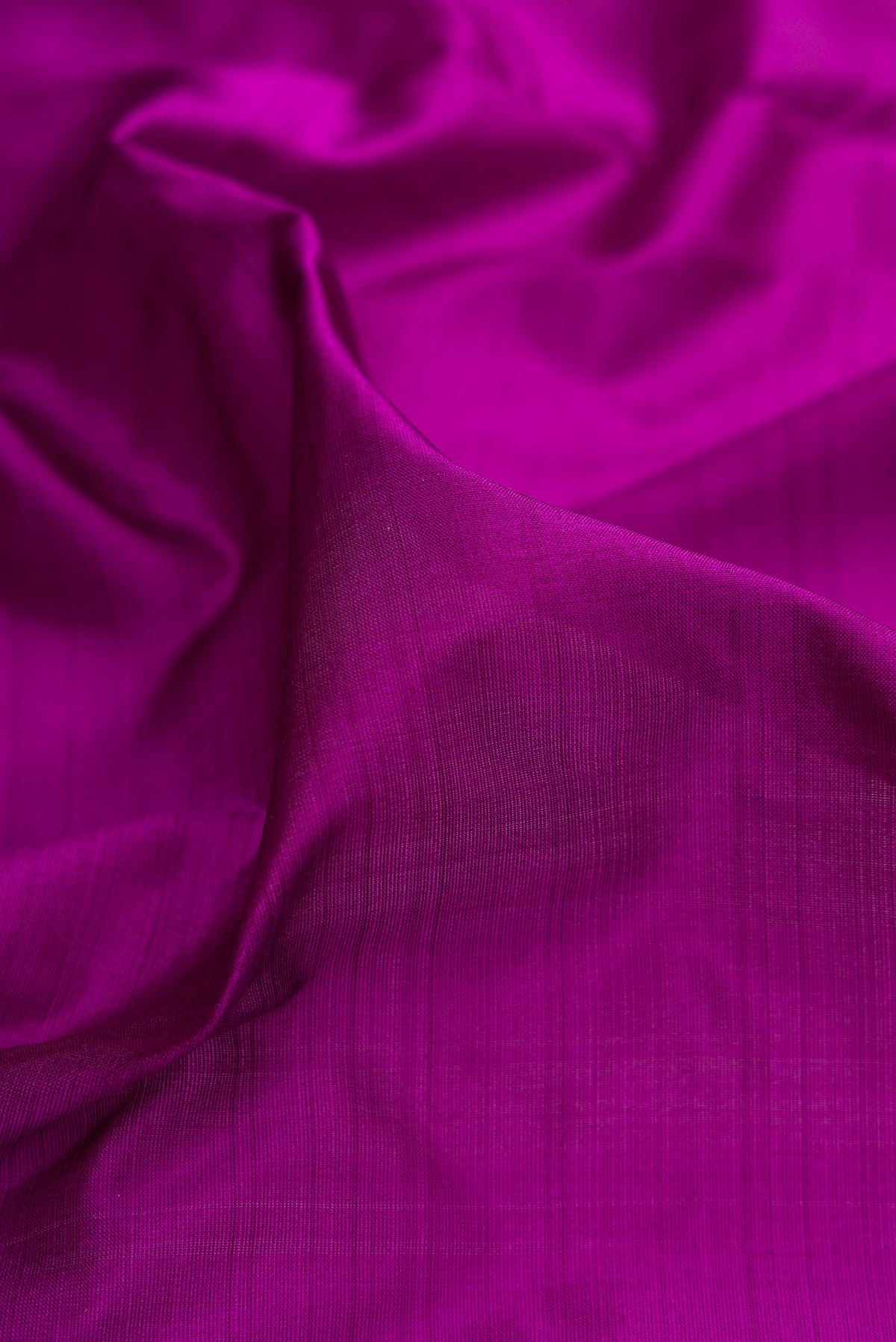 Close up of Pure Silk Purple Kanjivaram Nine Yards Saree with Plain Body and Zari Border.  displaying folds