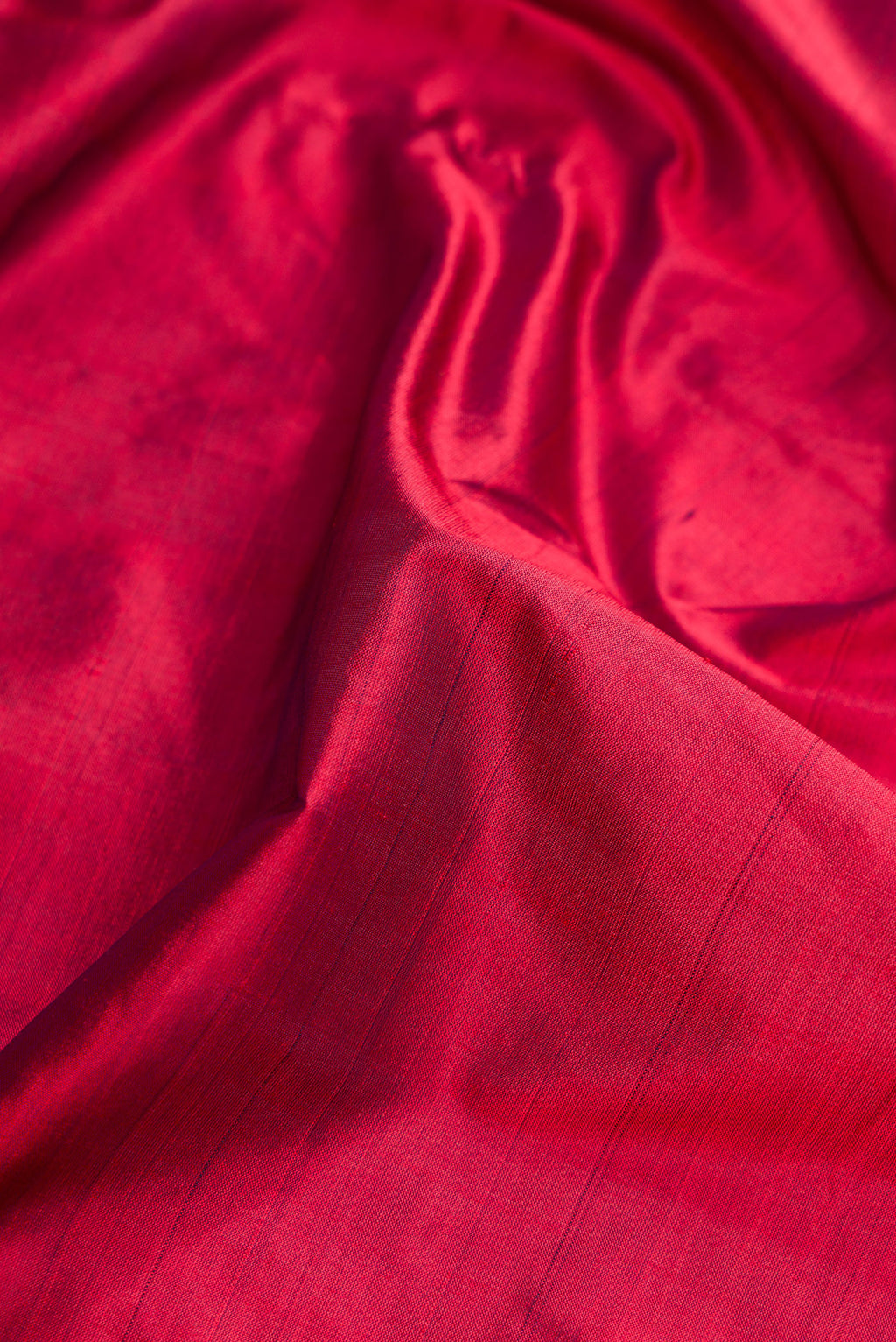 Close up of Maroon Dual Tone Kanjivaram Silk Nine Yards Saree with Plain Body and Zari Border.  displaying folds