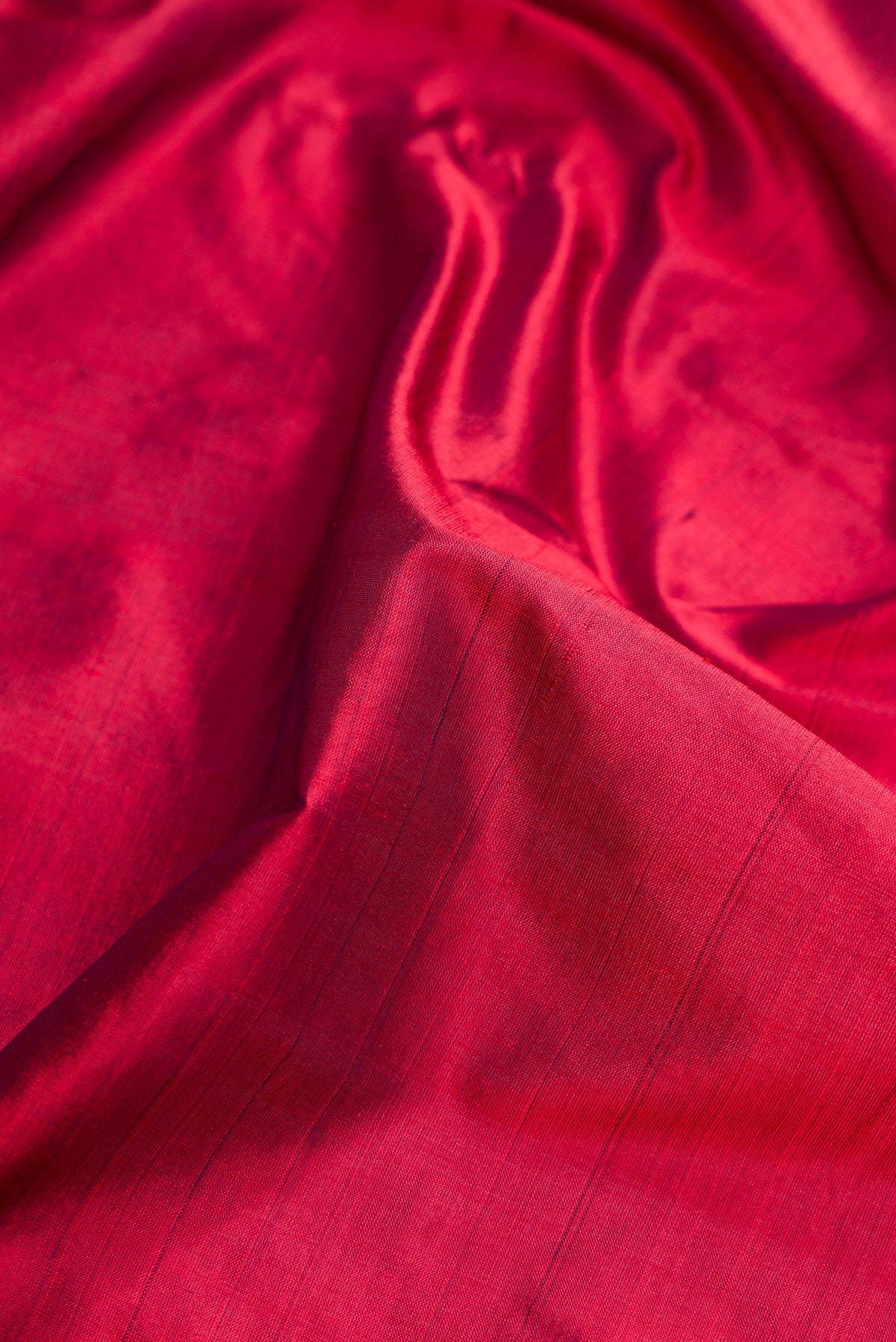 Close up of Maroon Dual Tone Kanjivaram Silk Nine Yards Saree with Plain Body and Zari Border.  displaying folds