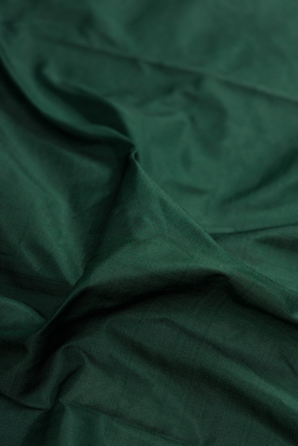 Close up of Bottle Green Kanchipuram Silk Nine Yards Saree with Plain Body and Zari Border.  displaying folds