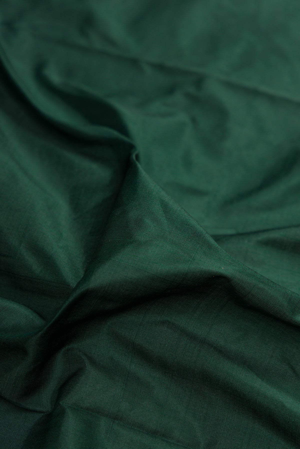 Close up of Bottle Green Kanchipuram Silk Nine Yards Saree with Plain Body and Zari Border.  displaying folds