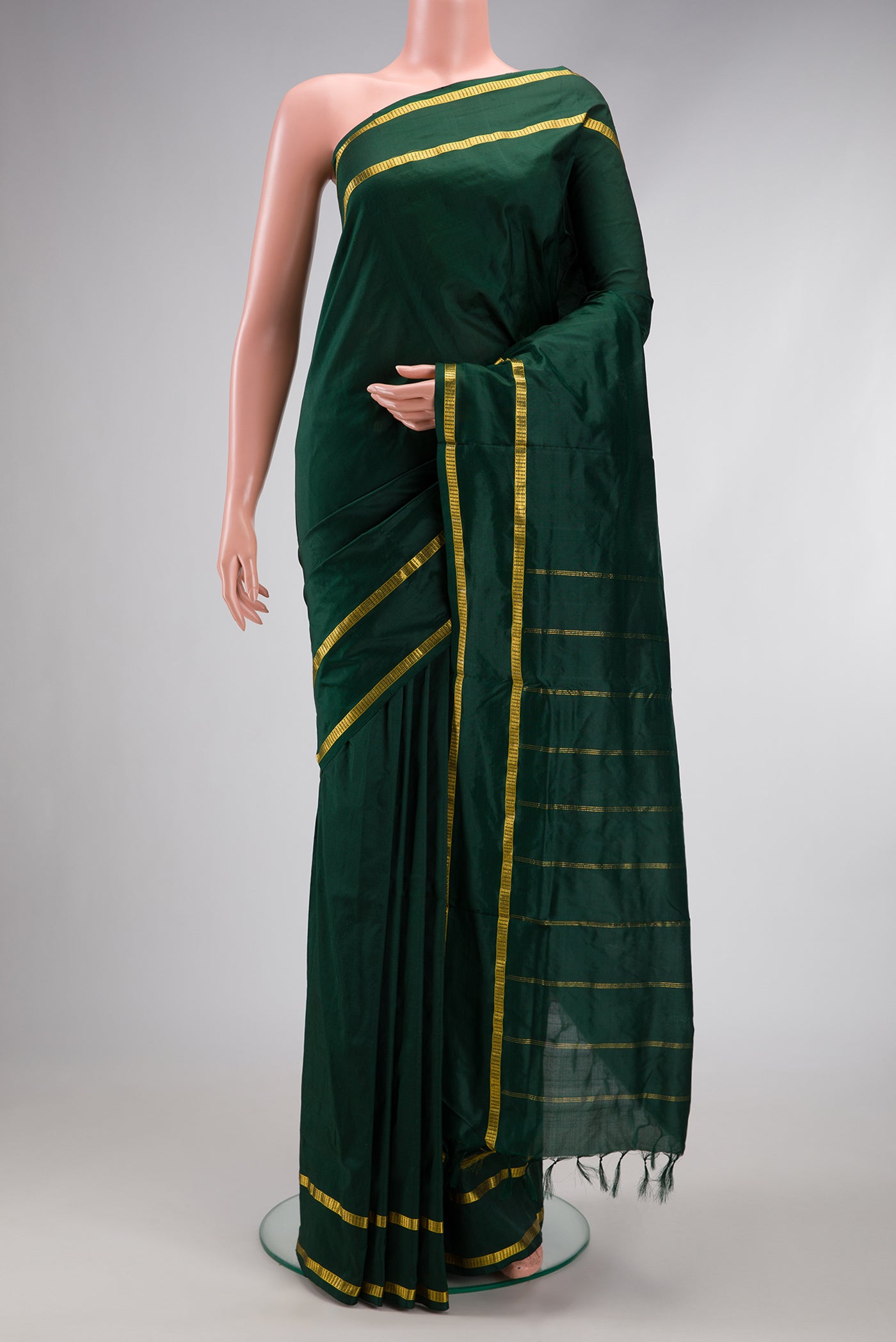Bottle Green Kanchipuram Silk Nine Yards Saree with Plain Body and Zari Border.  displayed on a mannequin