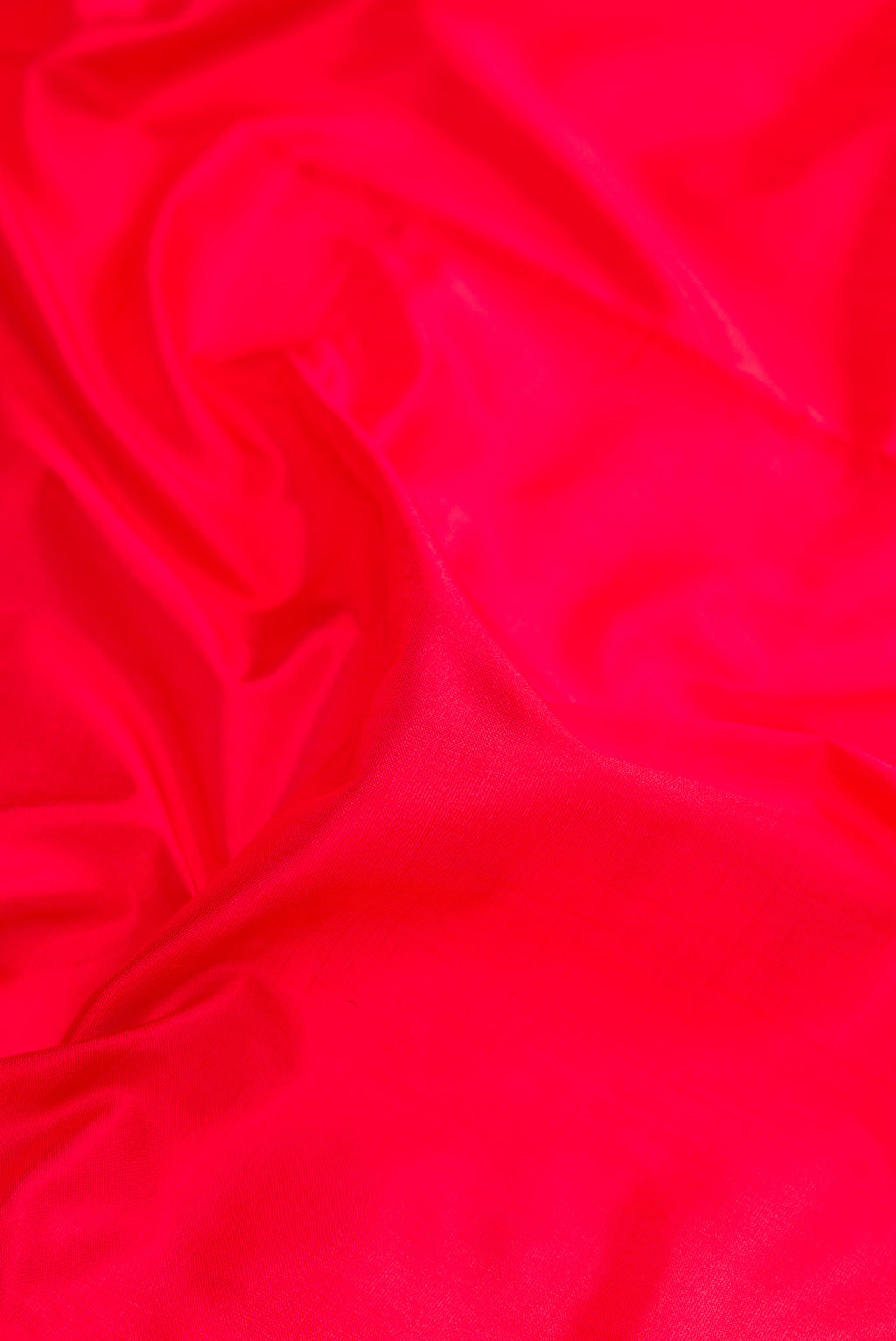 Close up of Red Kanjivaram Silk Nine Yards Saree with Plain Body and Zari Border.  displaying folds