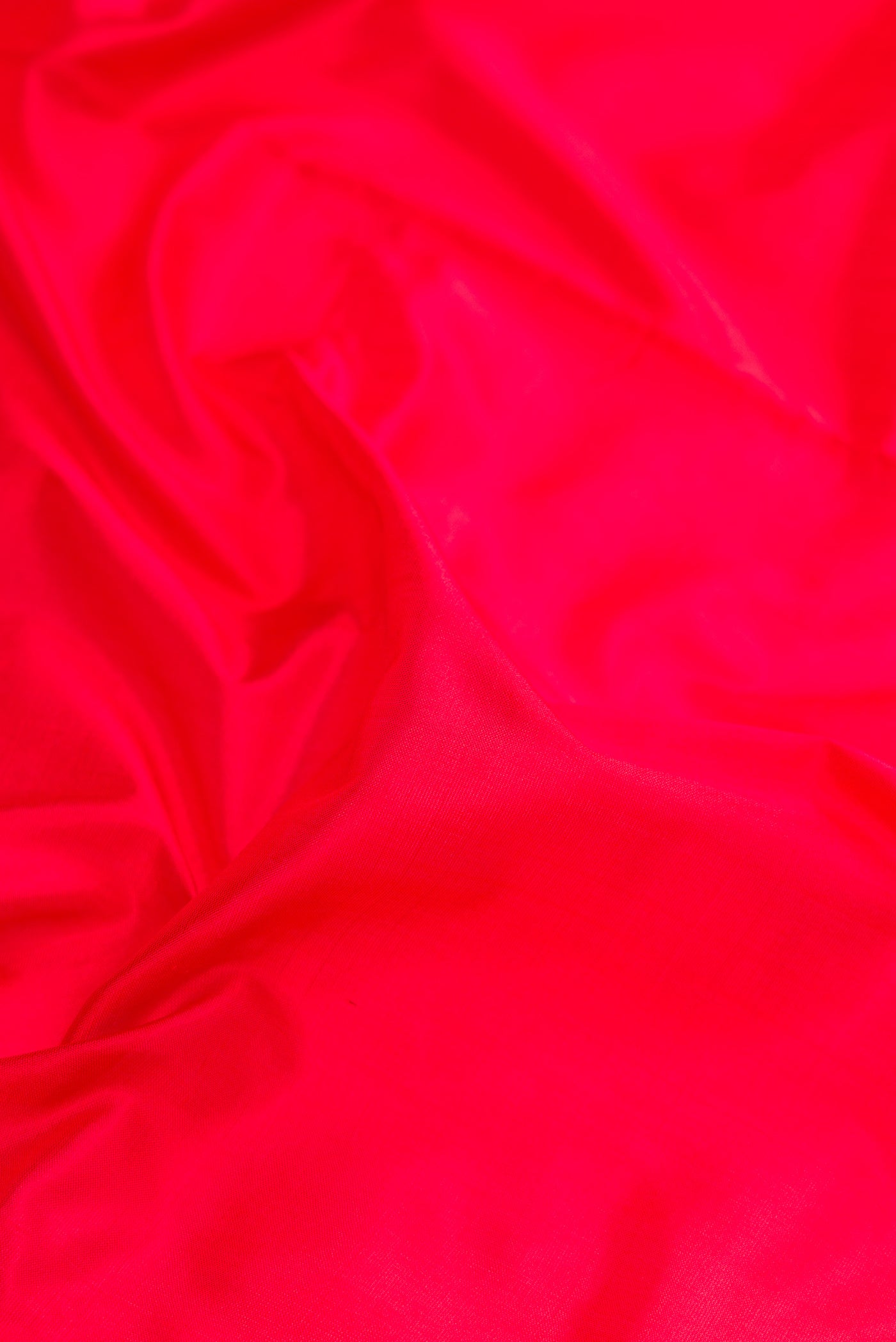 Close up of Red Kanjivaram Silk Nine Yards Saree with Plain Body and Zari Border.  displaying folds