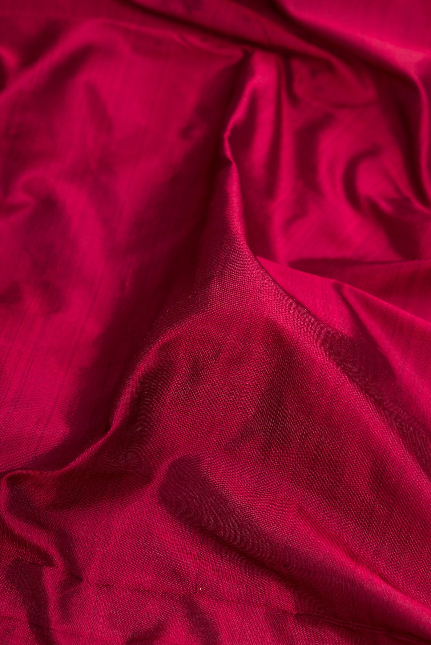 Close up of Maroon Dual Tone Kanjivaram Silk Nine Yards Saree with Plain Body and Zari Border.  displaying folds