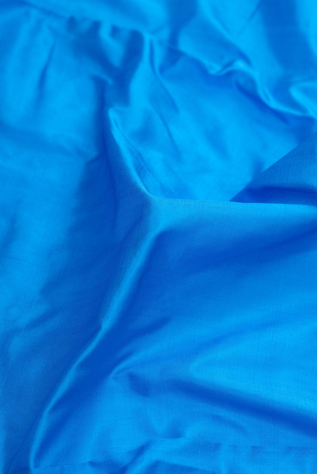 Close up of Sky Blue Dual Tone Kanjivaram Silk Nine Yards Saree with Plain Body and Zari Border.  displaying folds