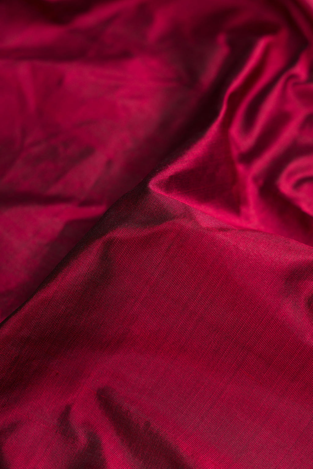 Close up of Maroon Dual Tone Kanjivaram Silk Nine Yards Saree with Plain Body and Zari Border.  displaying folds