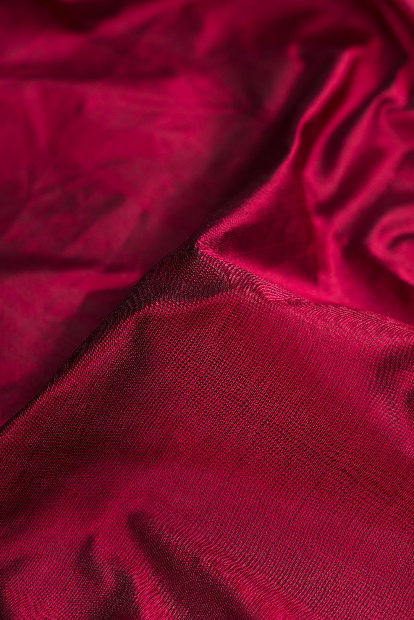 Close up of Maroon Dual Tone Kanjivaram Silk Nine Yards Saree with Plain Body and Zari Border.  displaying folds