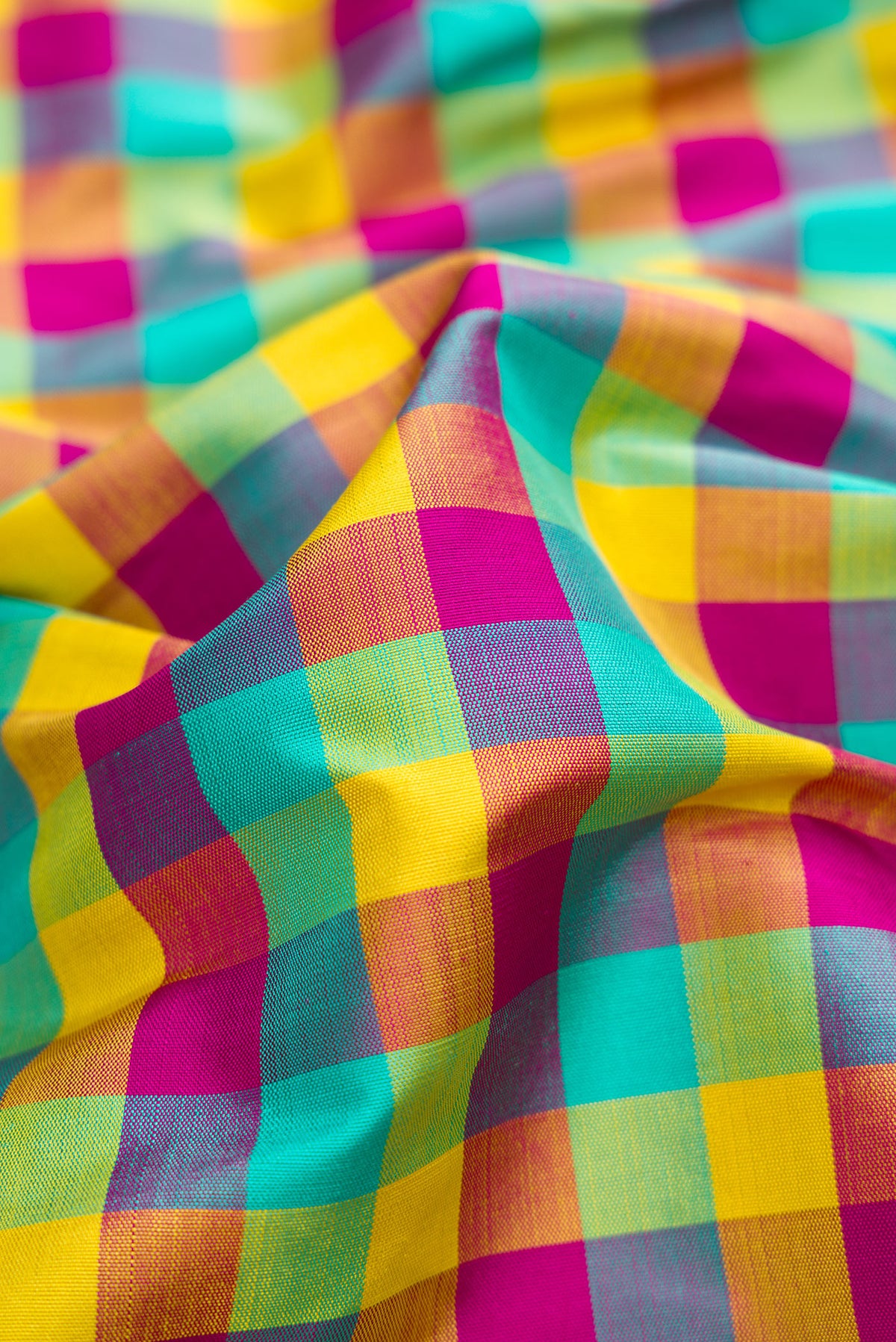Close up of Pure Silk Pure Zari Sea Green , Yellow and Dark PInk Color Kanchipuram Nine Yards Saree with Checked design on the body and Zari Border.  displaying folds