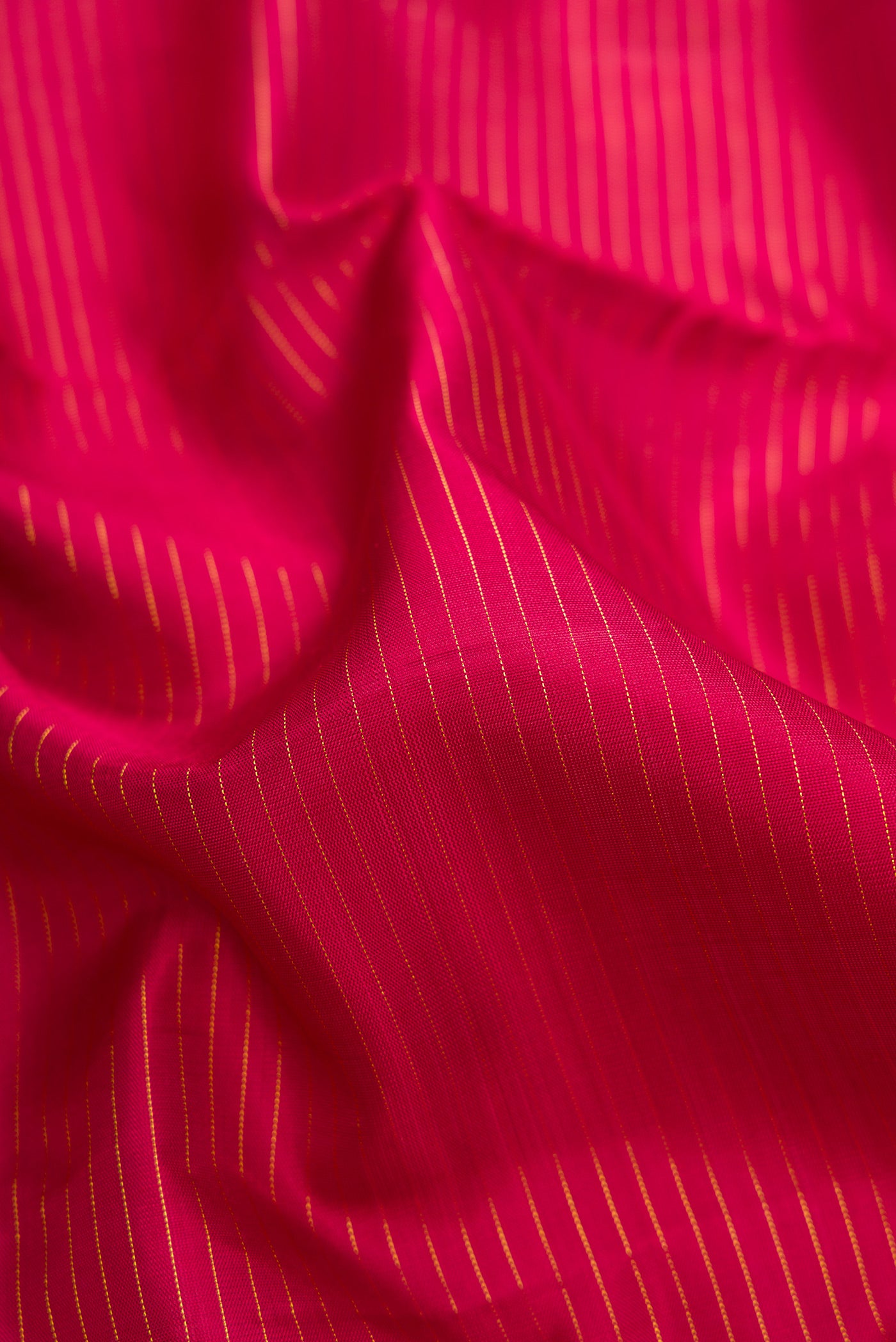 Close up of Pure Silk Pure Zari Maroon Dual Tone Kanjivaram Nine Yards Saree with Stripes on the body and Zari Border.  displaying folds