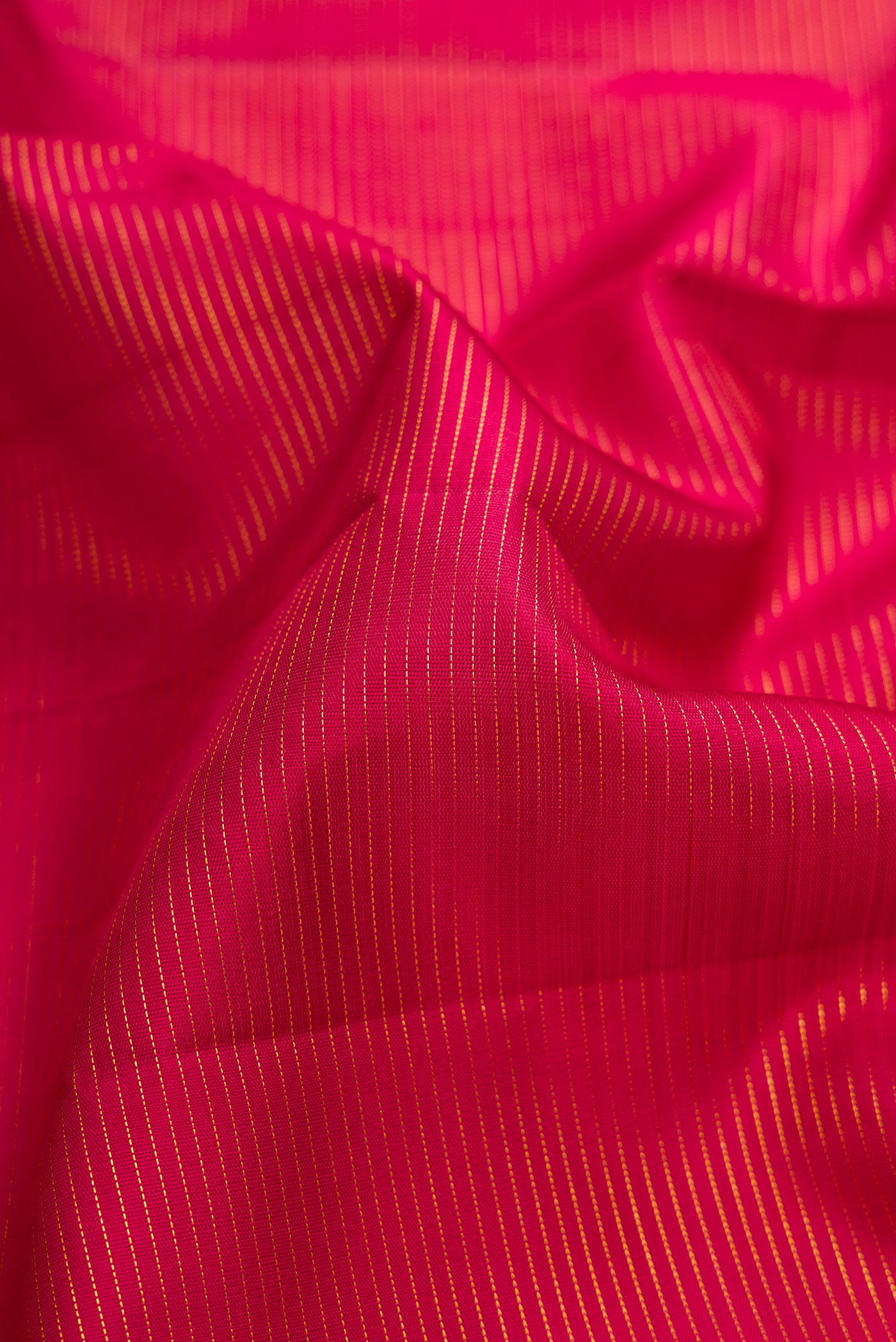 Close up of Pure Silk Pure Zari Maroon Dual Tone Kanchipuram Nine Yards Saree with Stripes on the body and Zari Border.  displaying folds