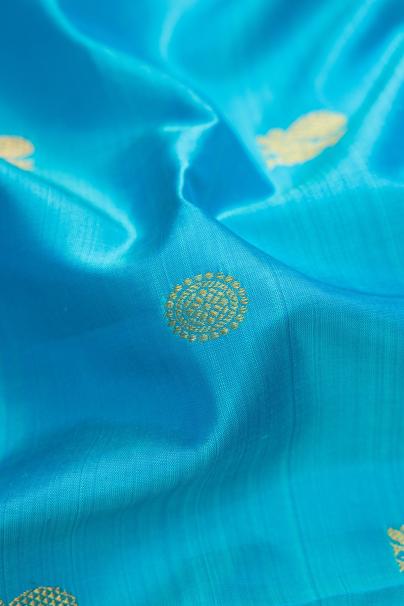 Close up of Pure Silk Pure Zari Sky Blue Dual Tone Kanchipuram Nine Yards Saree with Zari Butta on the body and Zari Border.  displaying folds