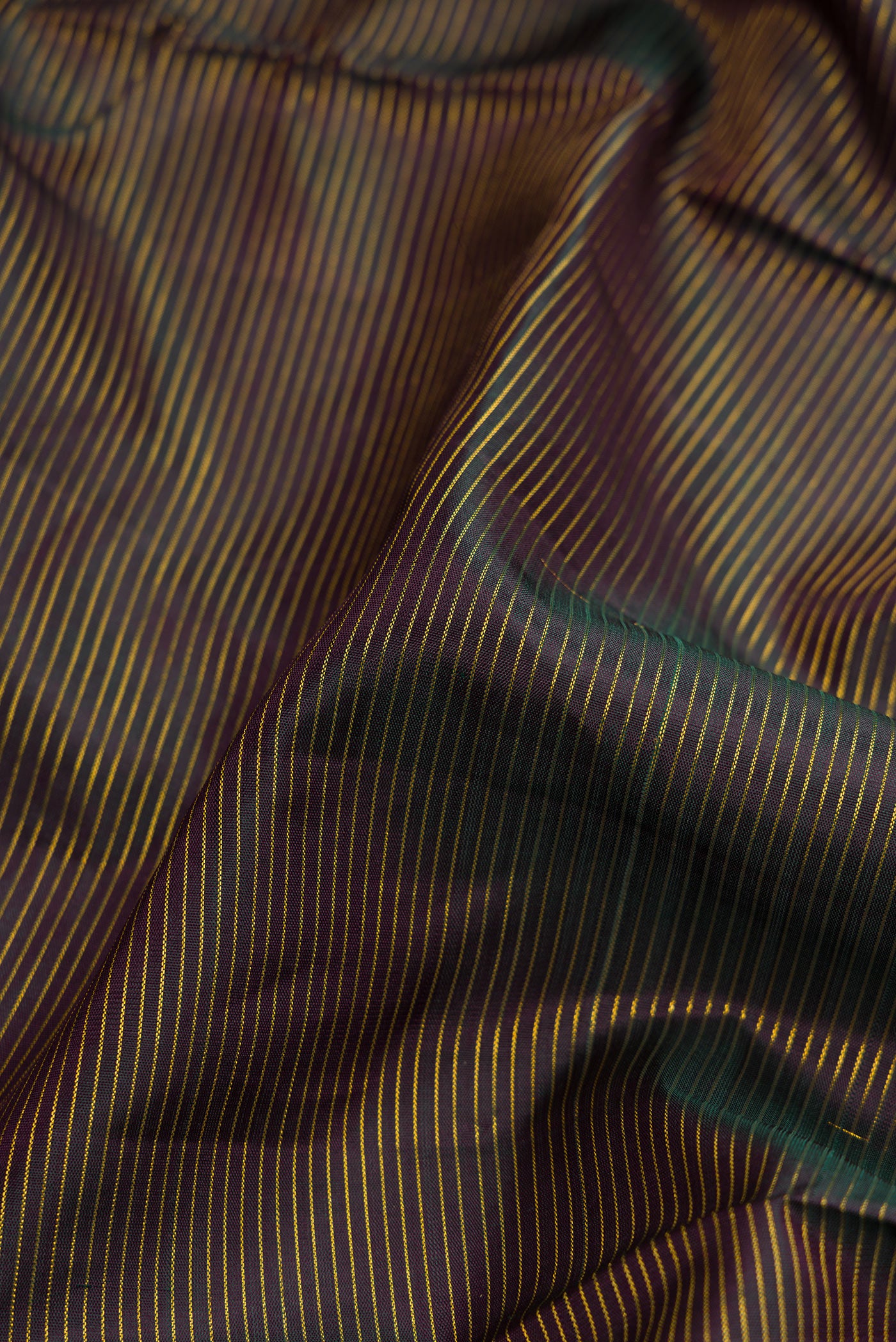 Close up of Black Dual Tone Kanjivaram Silk Nine Yards Saree with Stripes on the body and Zari Border.  displaying folds
