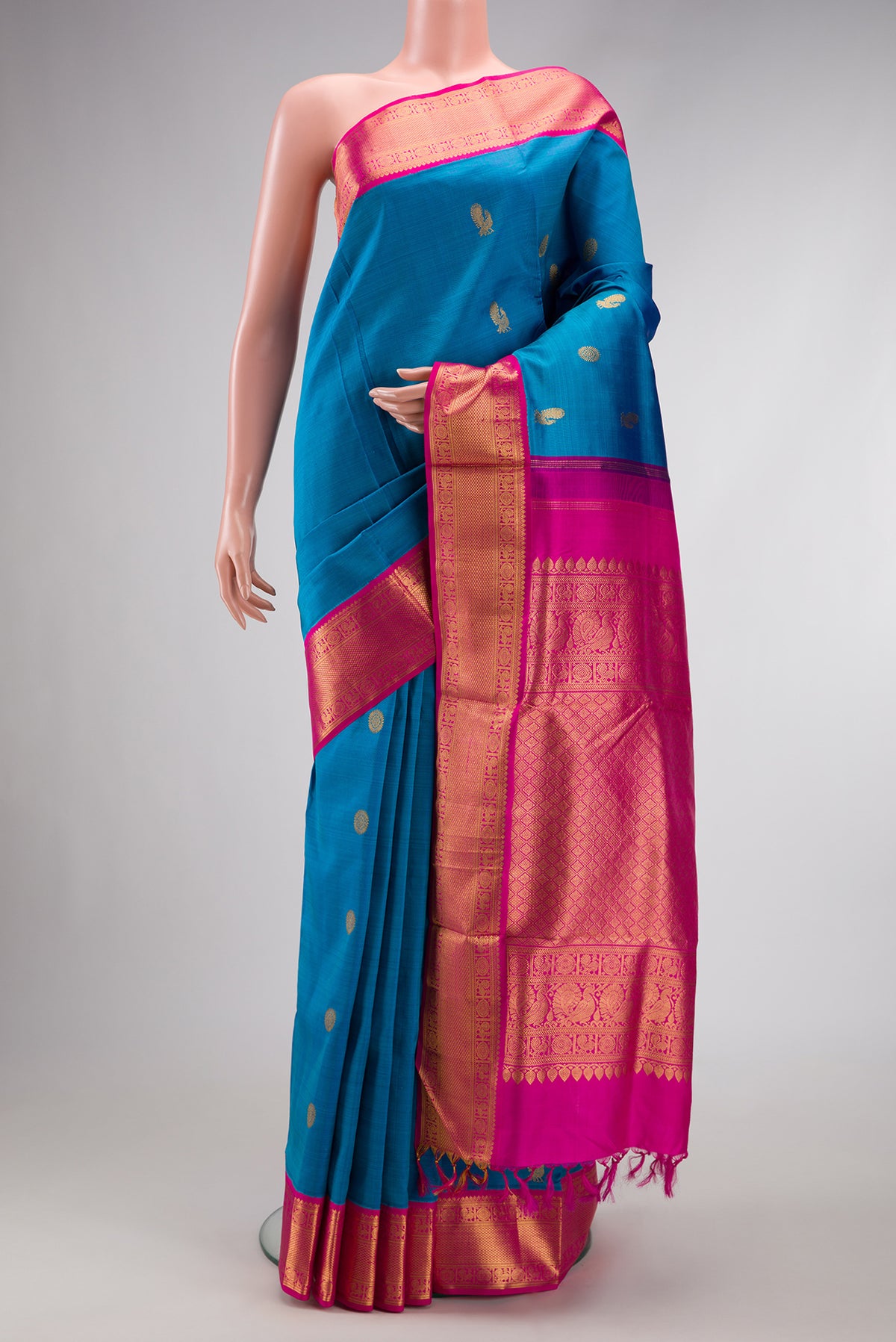 Pure Silk Pure Zari Peacock Blue Dual Tone Kanchipuram Nine Yards Saree with Zari Butta on the body and Zari Border.  displayed on a mannequin