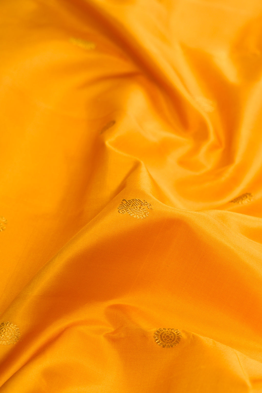 Close up of Pure Silk Pure Zari Yellow Dual Tone Kanchipuram Nine Yards Saree with Zari Butta on the body and Zari Border.  displaying folds