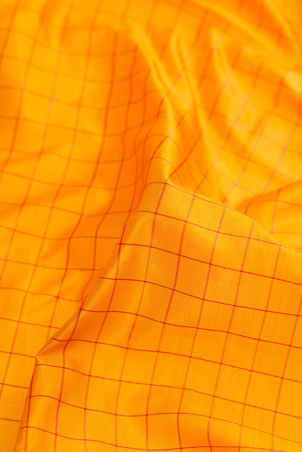 Close up of Mustard Dual Tone Kanchipuram Silk Nine Yards Saree with Checked design on the body and Zari Border.  displaying folds
