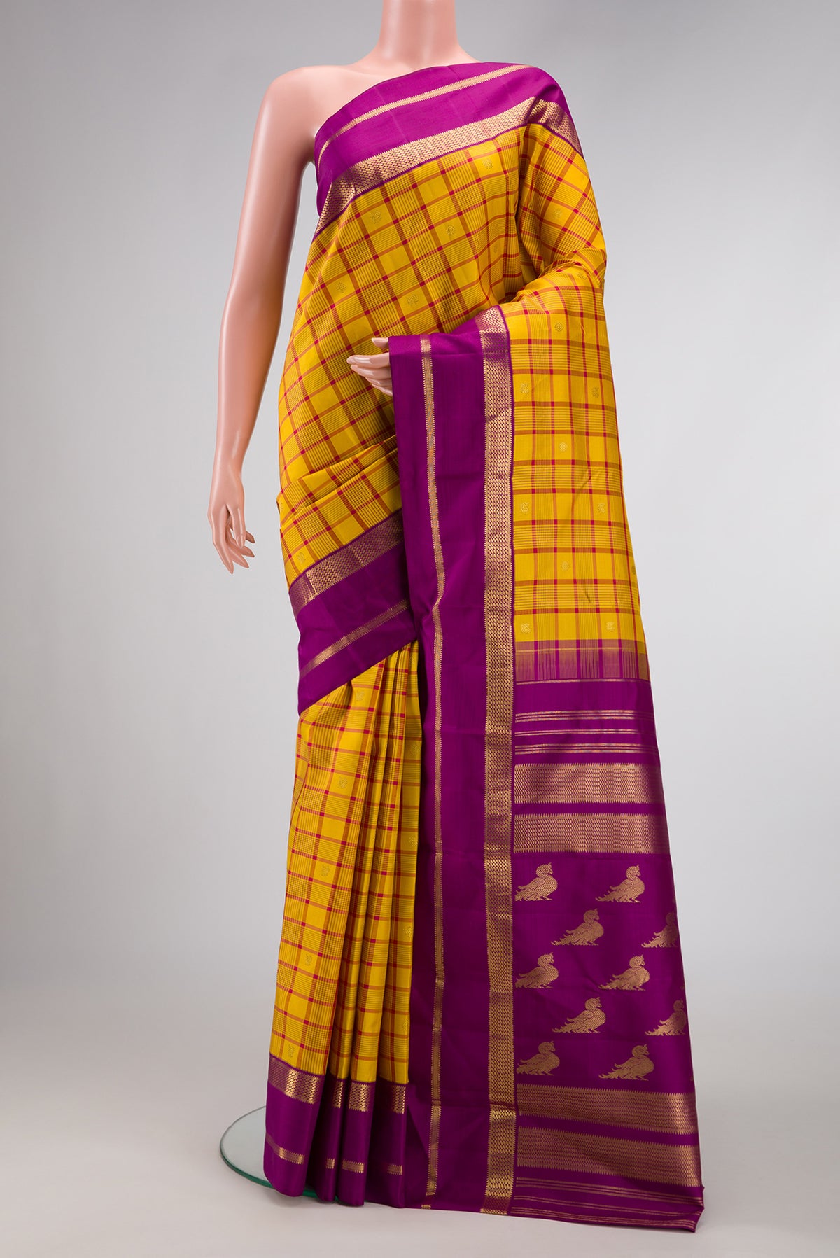 Pure Silk Pure Zari Mustard Dual Tone Kanjivaram Saree with Checked design on the body and Zari Border.  displayed on a mannequin