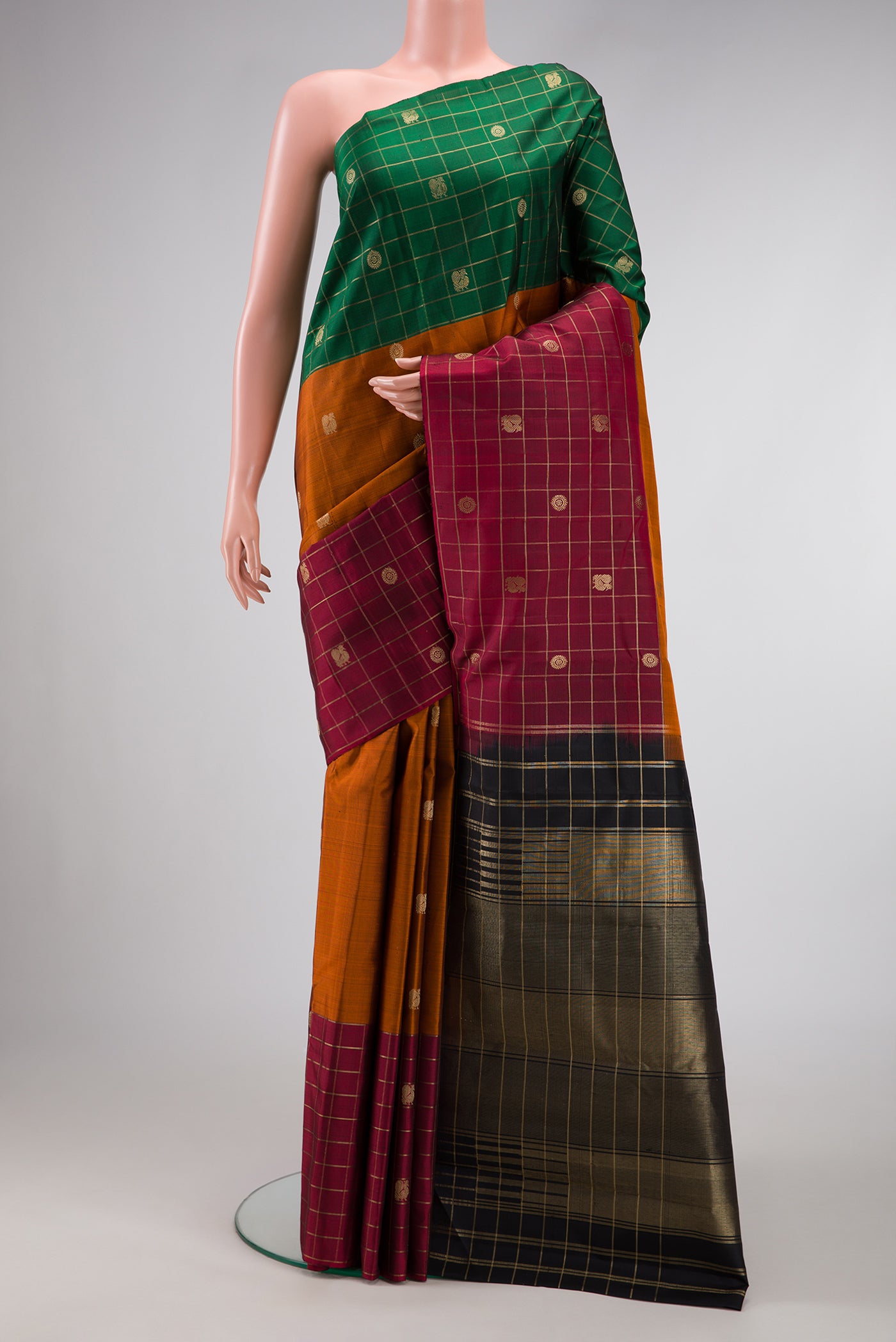 Brick Orange Dual Tone Kanjivaram Silk Saree with Zari Butta on the body and Ganga Jamuna Border.  displayed on a mannequin