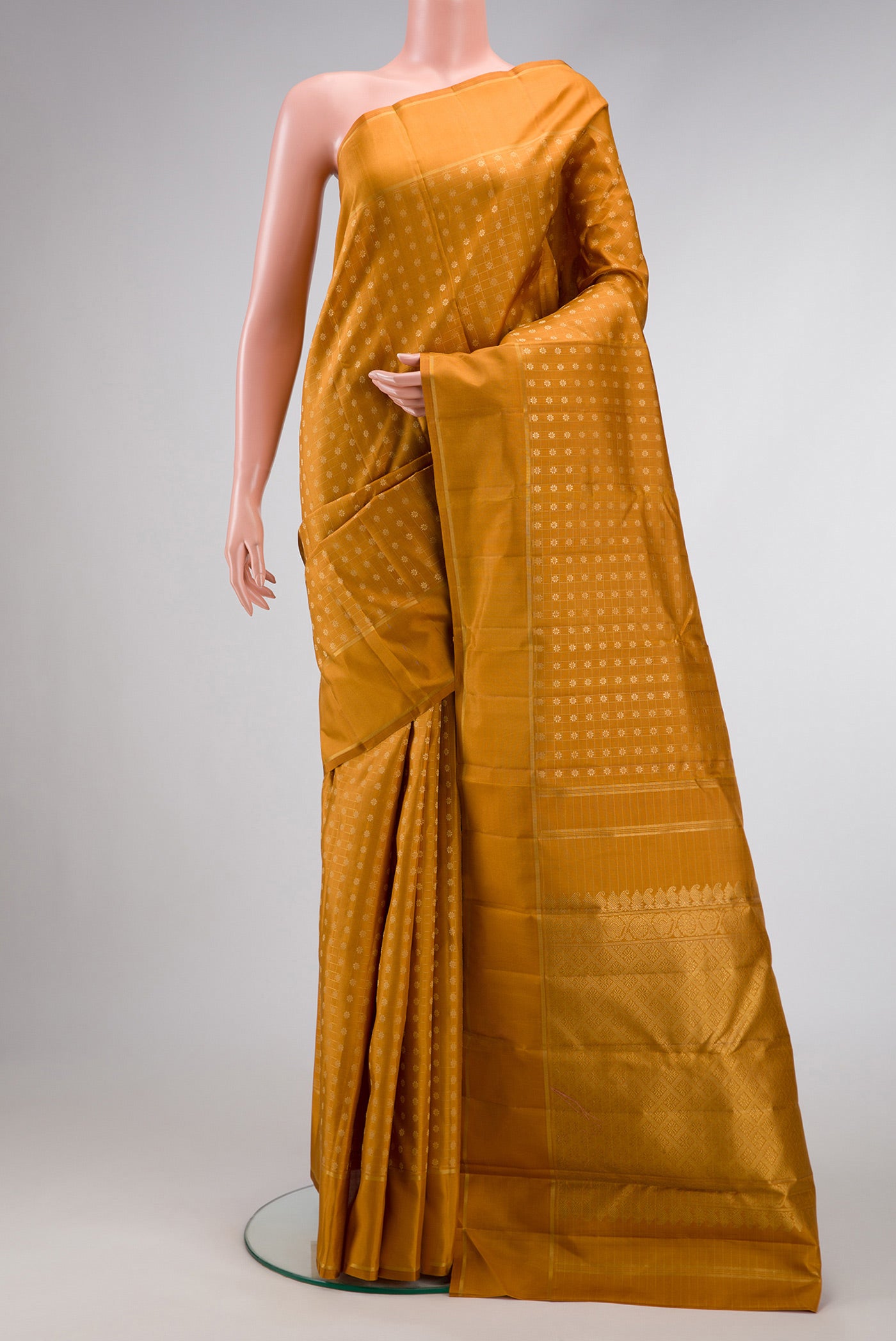 Mustard Dual Tone Kanchipuram Silk Saree with Zari Butta on the body and Zari Border.  displayed on a mannequin