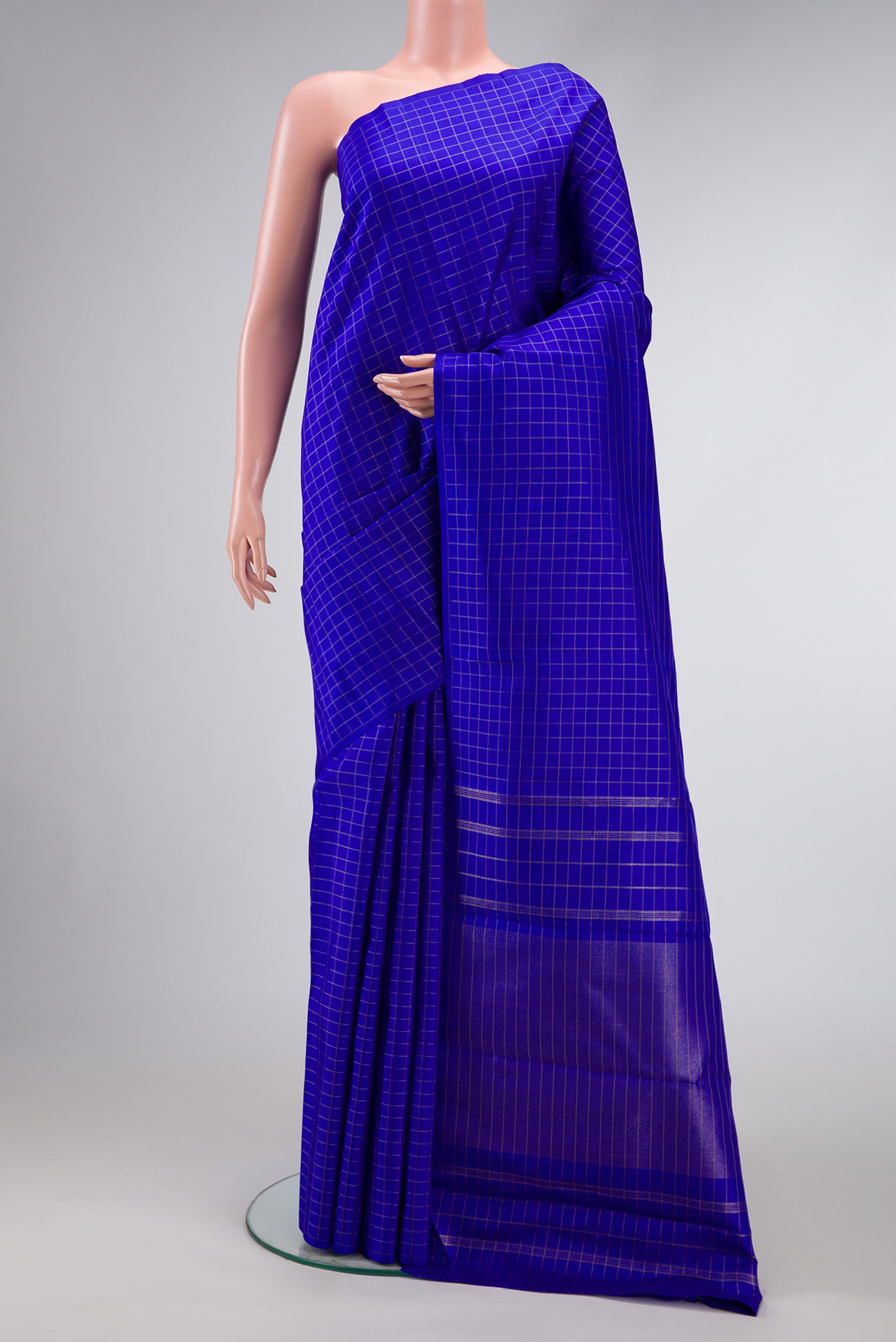 Pure Silk Pure Zari Royal Blue Dual Tone Kanchipuram Saree with Checked design on the body and Without Border.  displayed on a mannequin