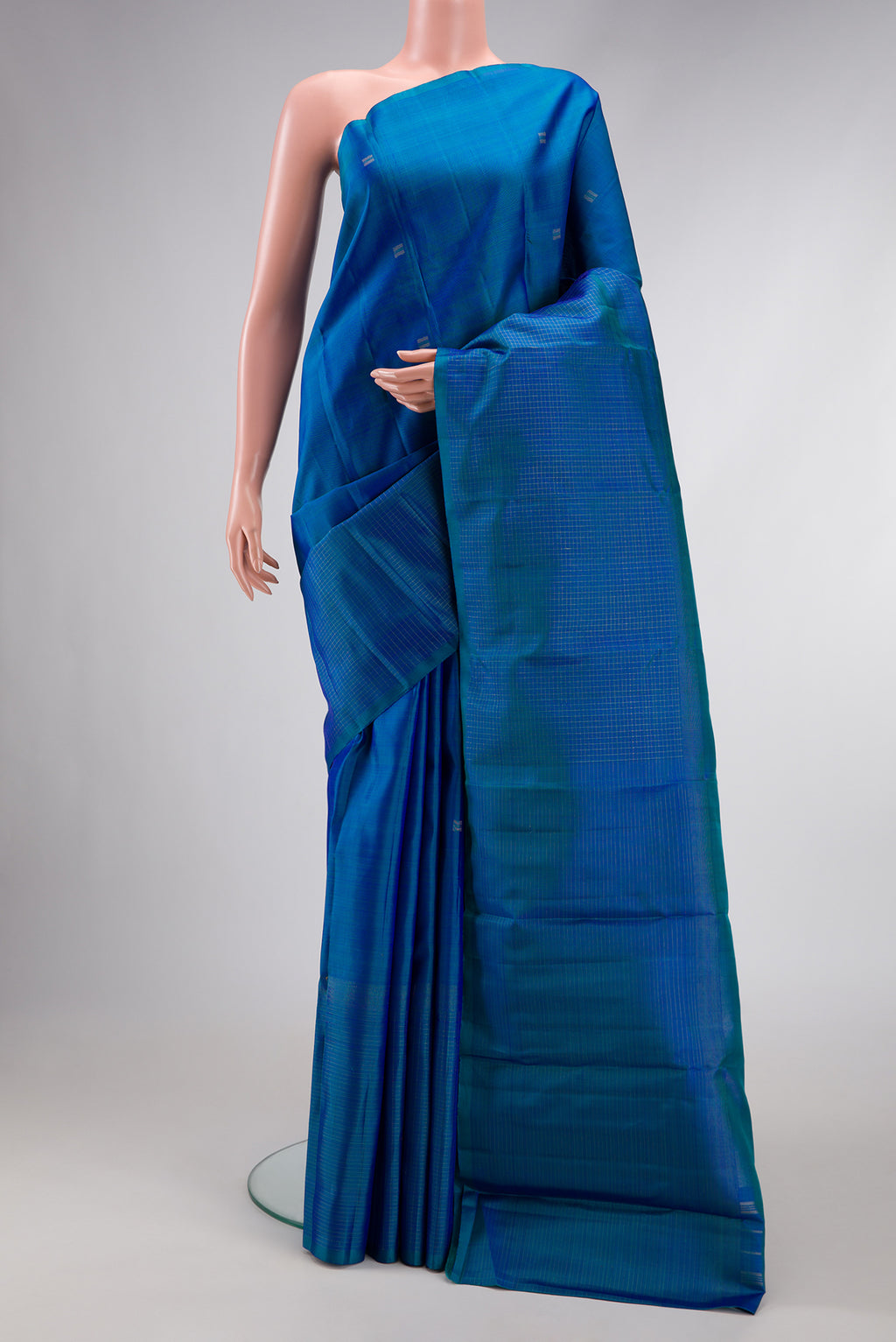 Pure Silk Pure Zari Peacock Blue Dual Tone Kanchipuram Saree with Zari Butta on the body and Zari Border.  displayed on a mannequin