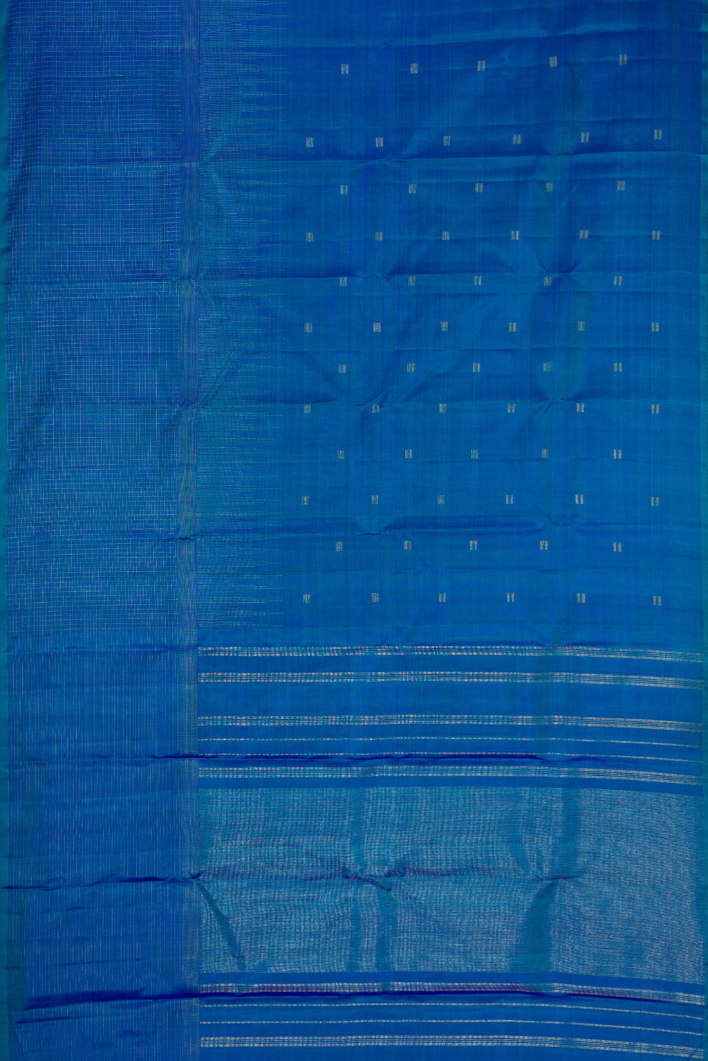 Flat view of Pure Silk Pure Zari Peacock Blue Dual Tone Kanchipuram Saree with Zari Butta on the body and Zari Border. 