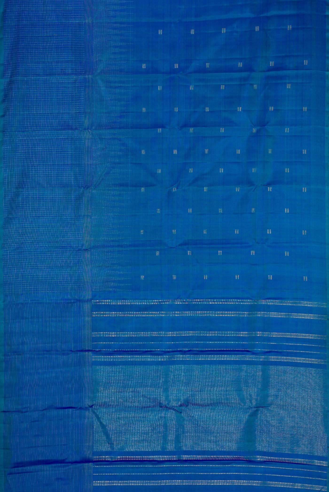 Flat view of Pure Silk Pure Zari Peacock Blue Dual Tone Kanchipuram Saree with Zari Butta on the body and Zari Border. 