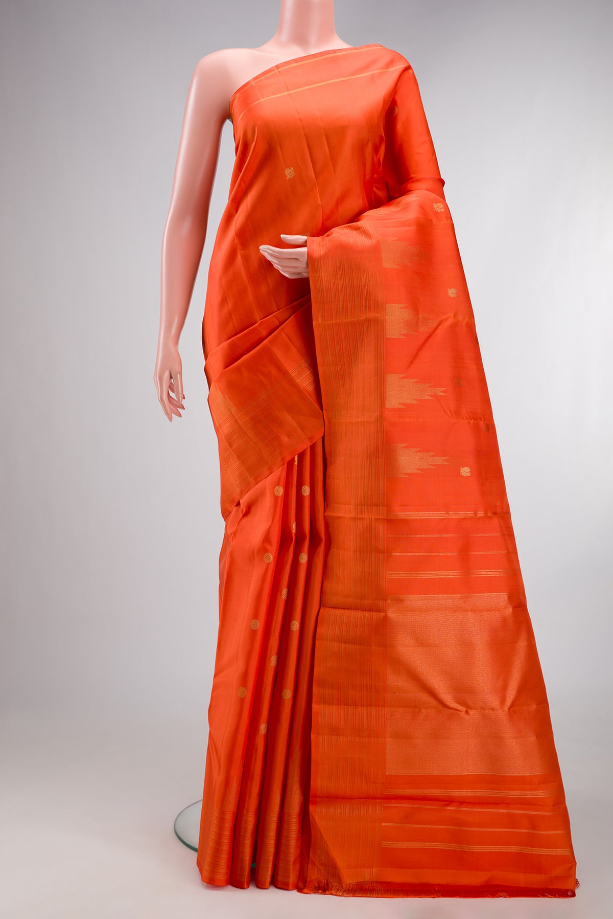 Pure Silk Pure Zari Orange Kanchipuram Saree with Zari Butta on the body and Fancy Border.  displayed on a mannequin
