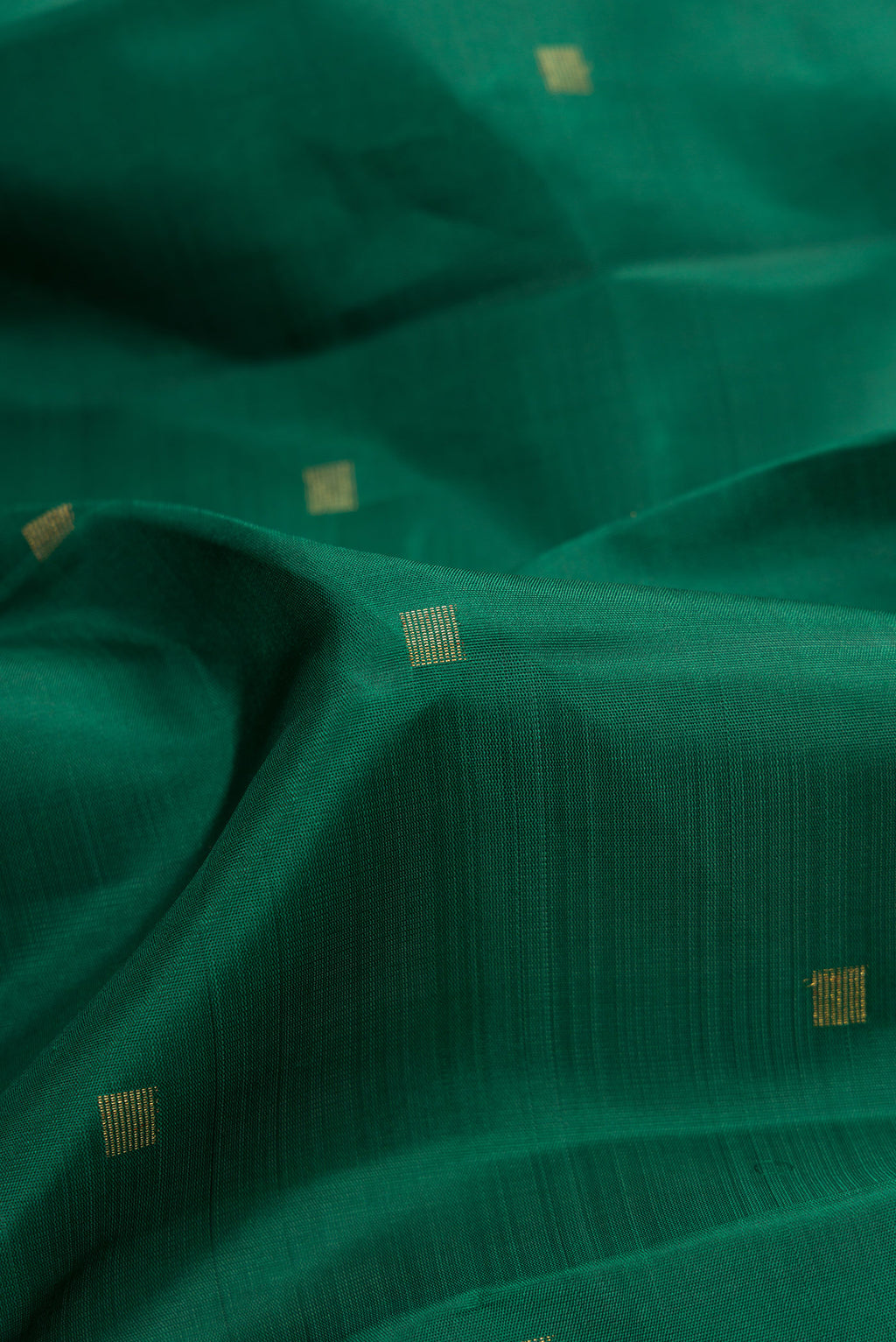 Close up of Pure Silk Pure Zari Bottle Green Dual Tone Kanchipuram Saree with Zari Butta on the body and Fancy Border.  displaying folds
