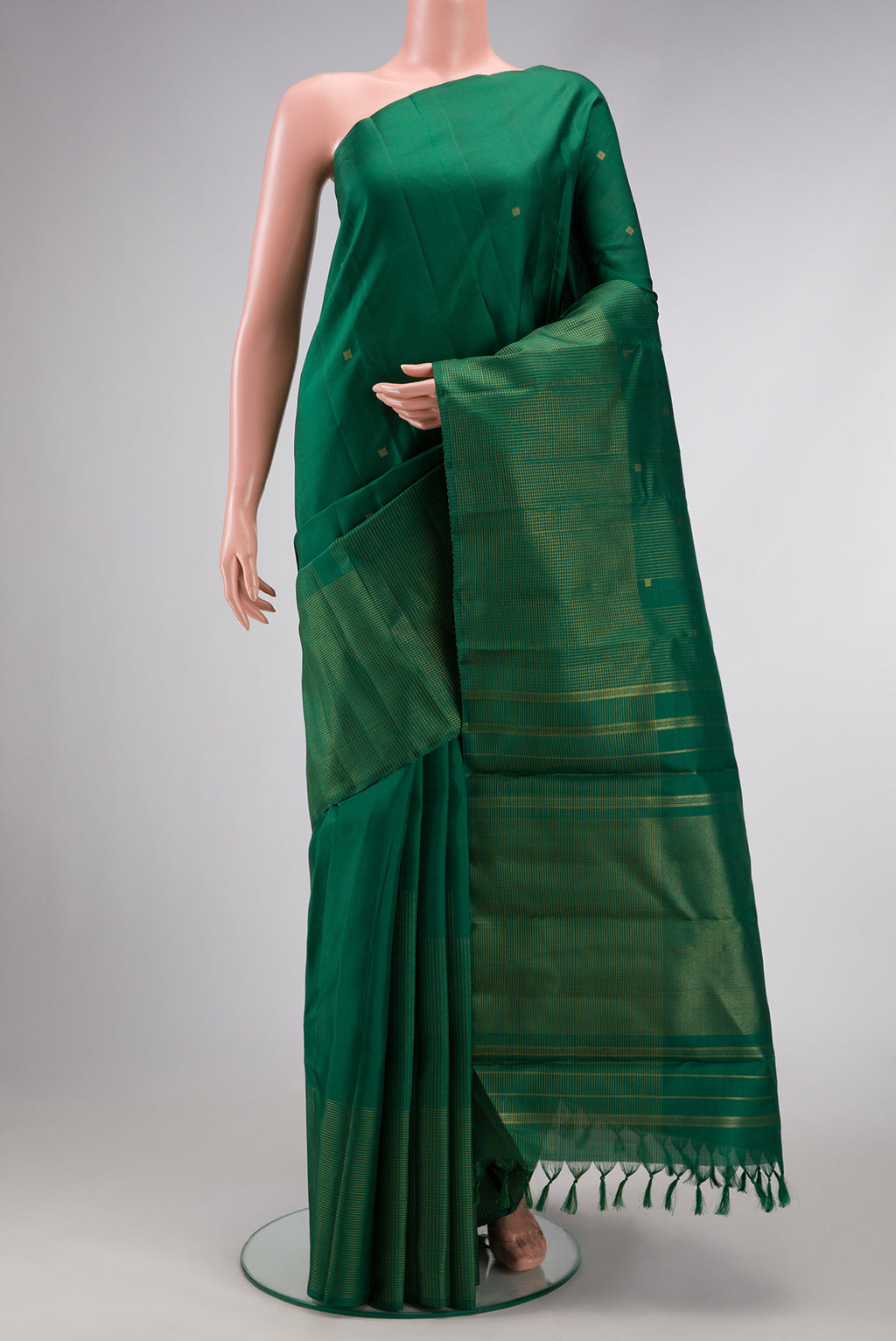 Pure Silk Pure Zari Bottle Green Dual Tone Kanchipuram Saree with Zari Butta on the body and Fancy Border.  displayed on a mannequin