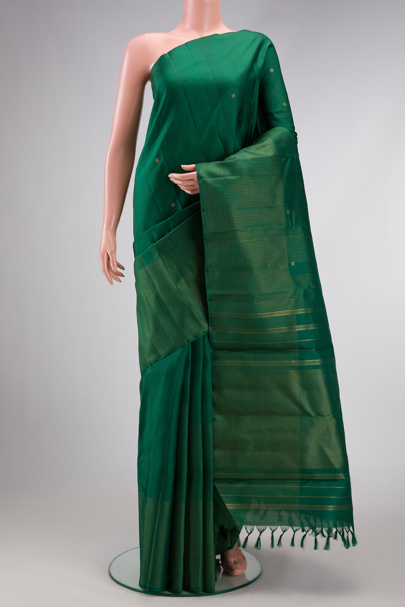 Pure Silk Pure Zari Bottle Green Dual Tone Kanchipuram Saree with Zari Butta on the body and Fancy Border.  displayed on a mannequin