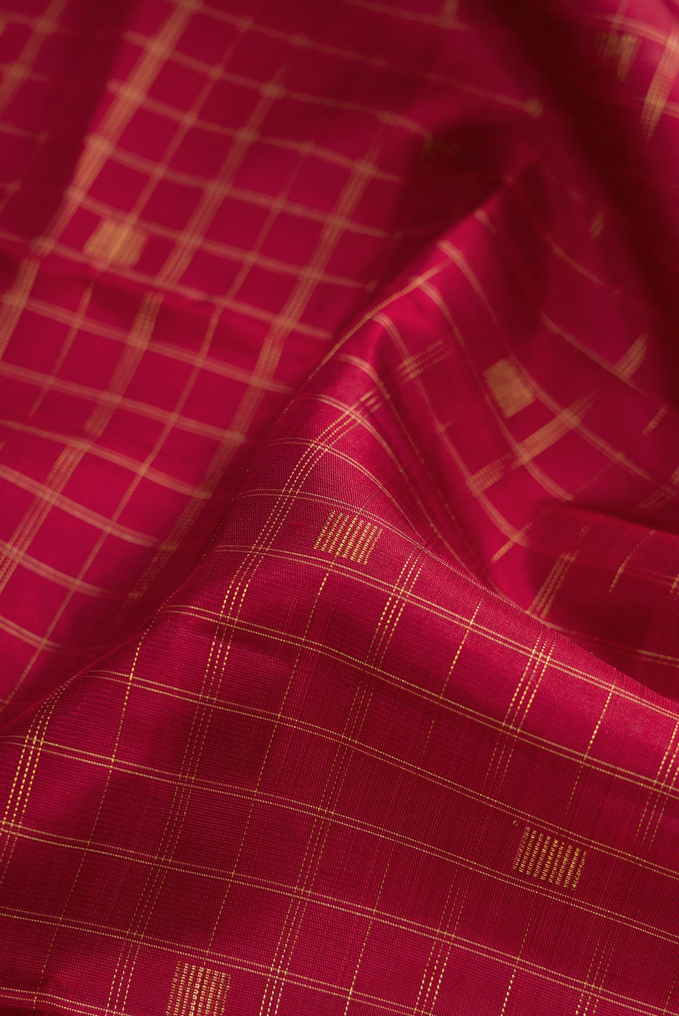 Close up of Pure Silk Pure Zari Maroon Dual Tone Kanchipuram Saree with Checked design on the body and Without Border.  displaying folds