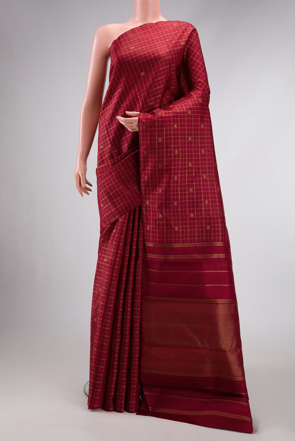 Pure Silk Pure Zari Maroon Dual Tone Kanchipuram Saree with Checked design on the body and Without Border.  displayed on a mannequin