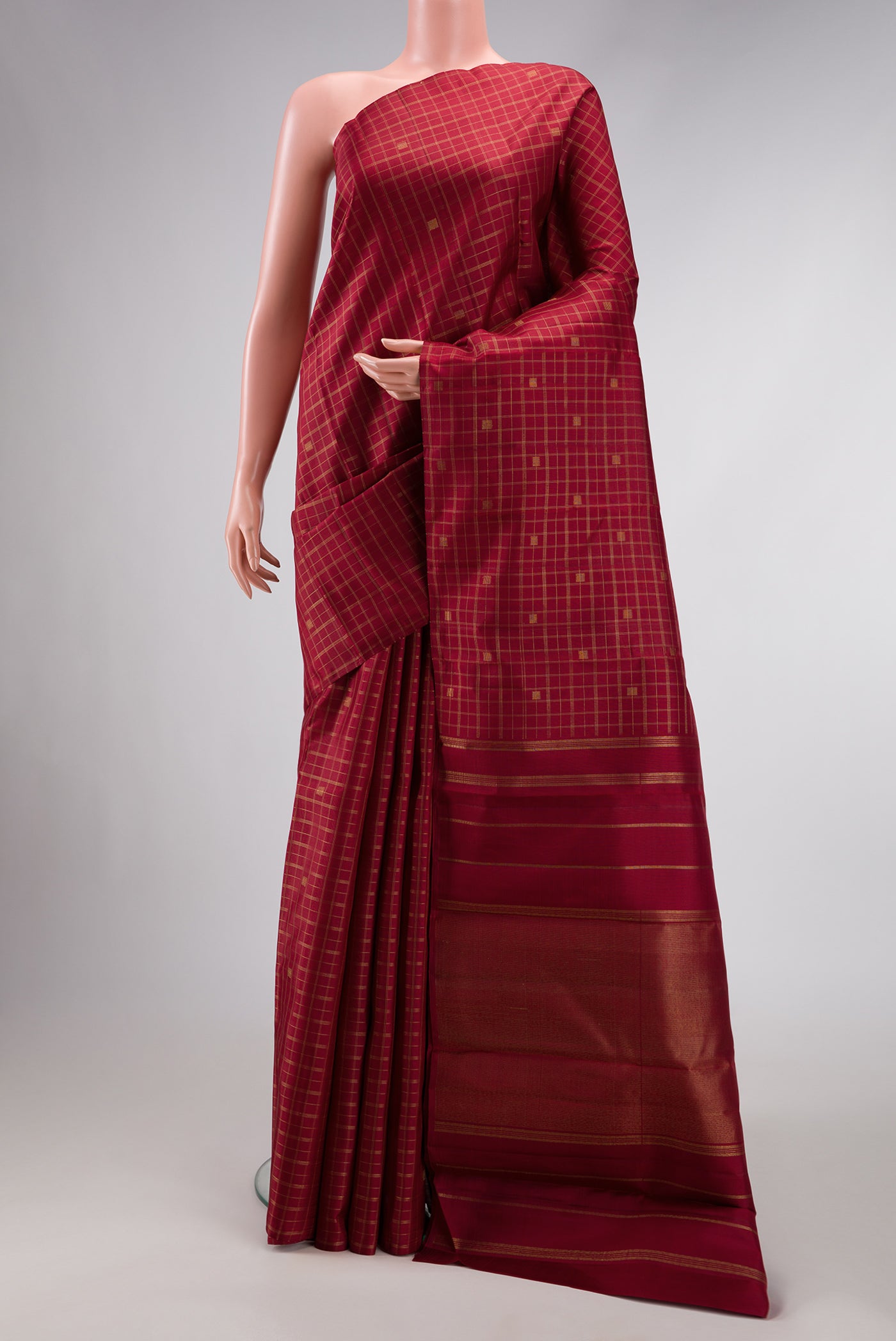 Pure Silk Pure Zari Maroon Dual Tone Kanchipuram Saree with Checked design on the body and Without Border.  displayed on a mannequin