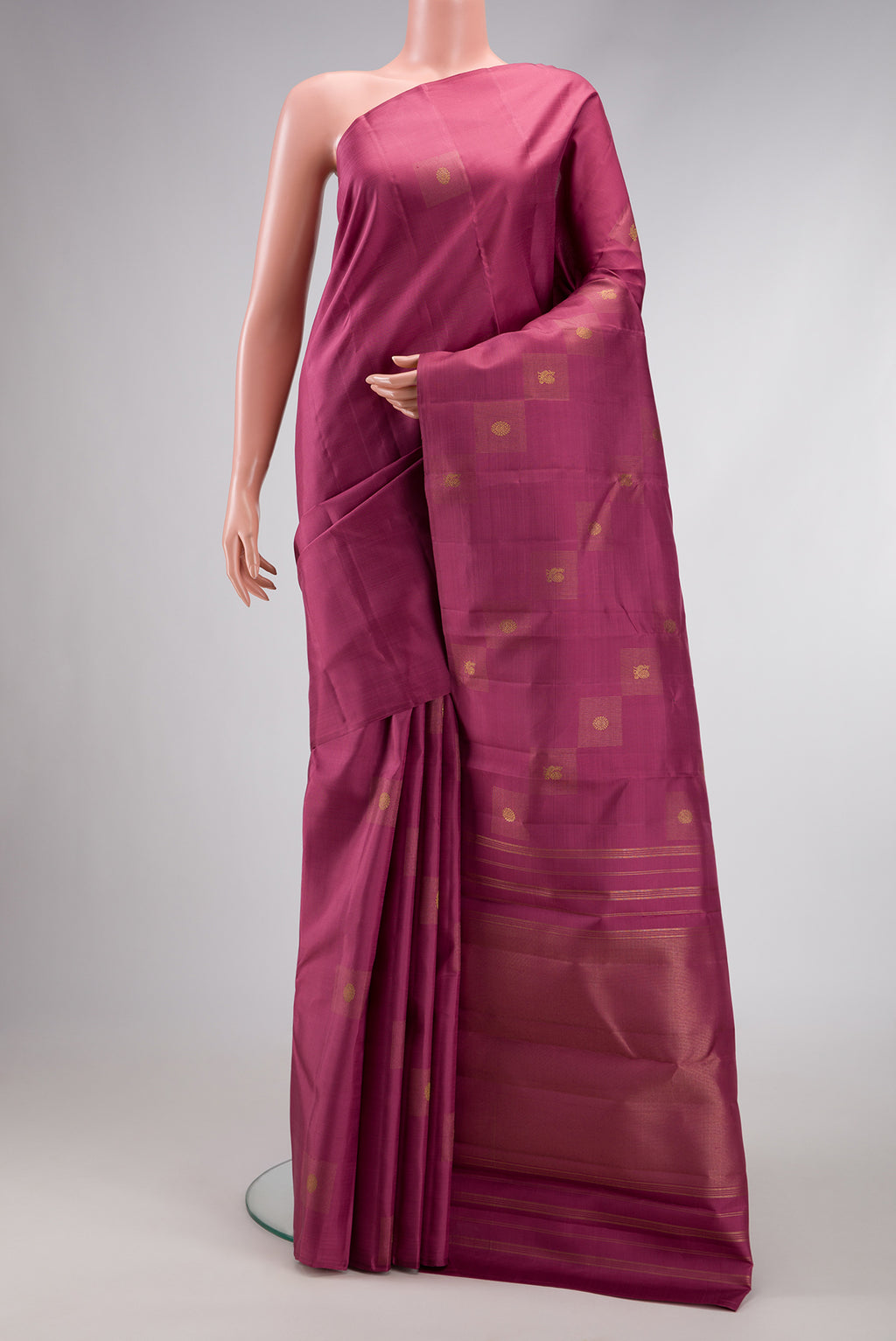 Pure Silk Pure Zari Rose Gold Dual Tone Kanjivaram Saree with Zari Butta on the body and Without Border.  displayed on a mannequin