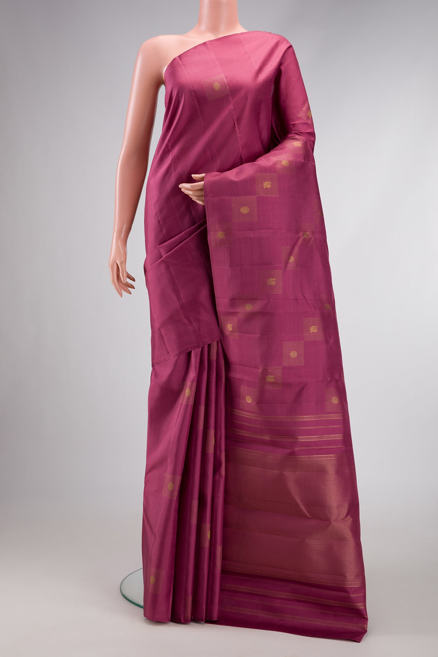 Pure Silk Pure Zari Rose Gold Dual Tone Kanjivaram Saree with Zari Butta on the body and Without Border.  displayed on a mannequin