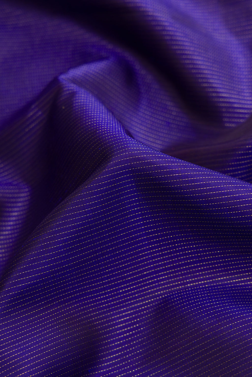 Close up of Pure Silk Pure Zari Navy Blue Dual Tone Kanchipuram Saree with Stripes on the body and Fancy Border.  displaying folds
