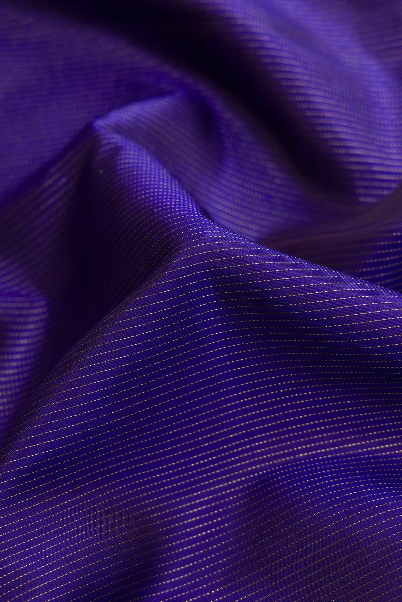 Close up of Pure Silk Pure Zari Navy Blue Dual Tone Kanchipuram Saree with Stripes on the body and Fancy Border.  displaying folds