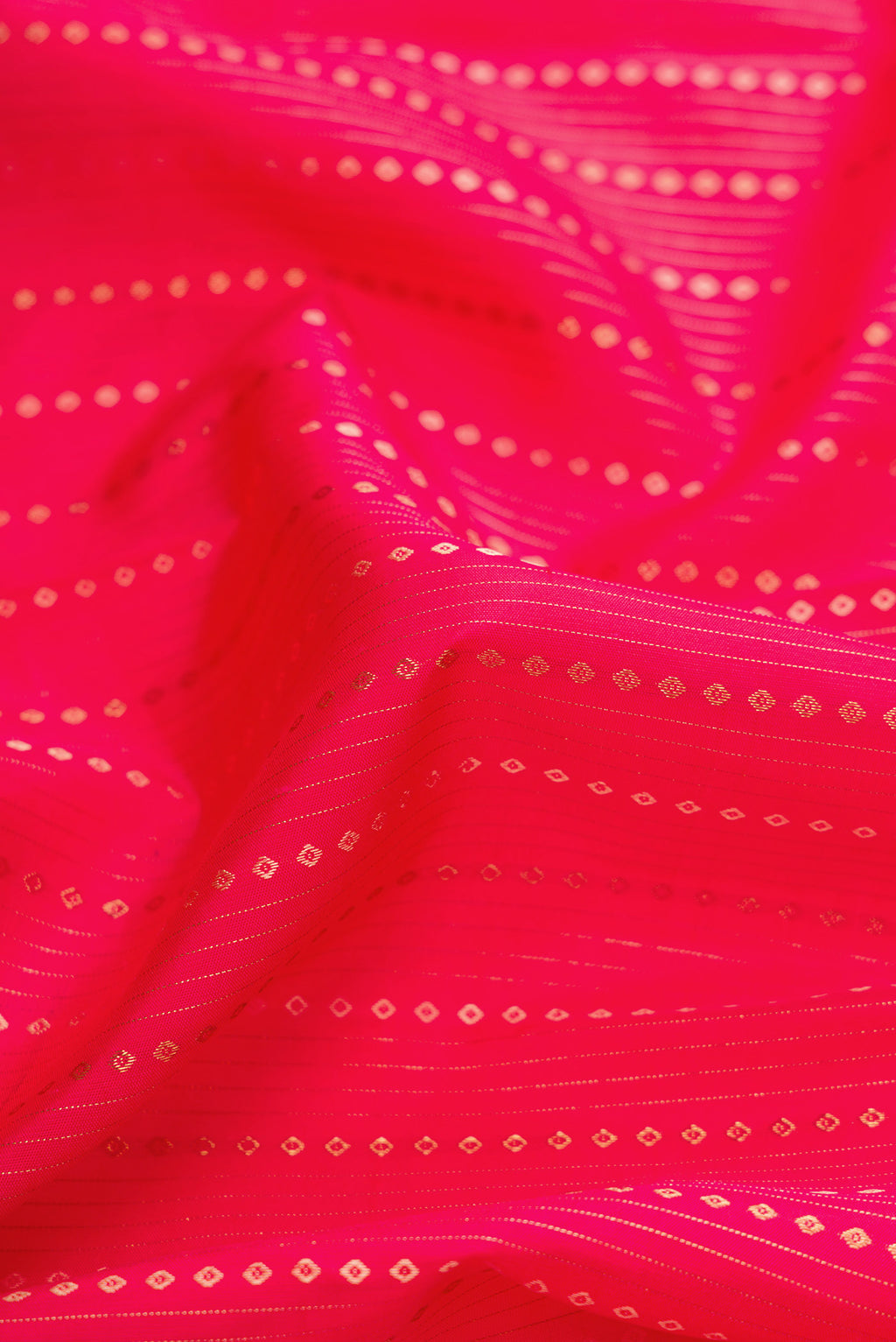 Close up of Pink Dual Tone Kanchipuram Silk Saree with Stripes on the body and Zari Border.  displaying folds