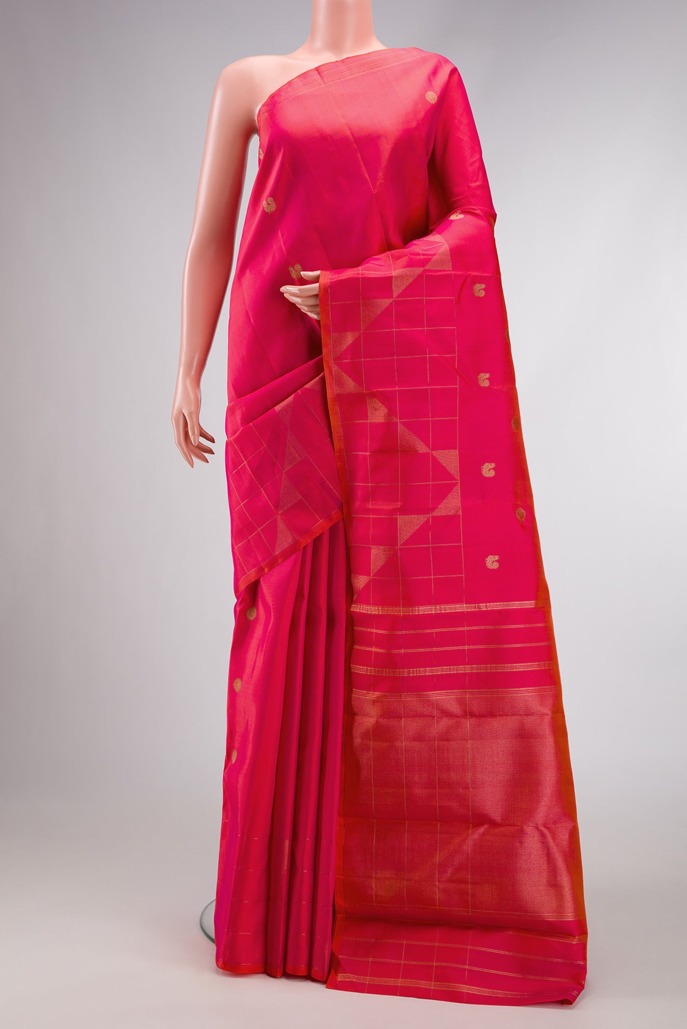 Pure Silk Pure Zari Coral Dual Tone Kanchipuram Saree with Zari Butta on the body and Fancy Border.  displayed on a mannequin