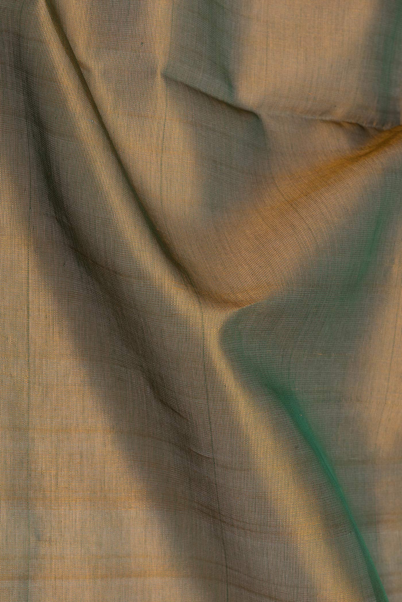 Close up of Mehandi Green Dual Tone Silk Cotton Saree with Plain Body and Zari Border.  displaying folds