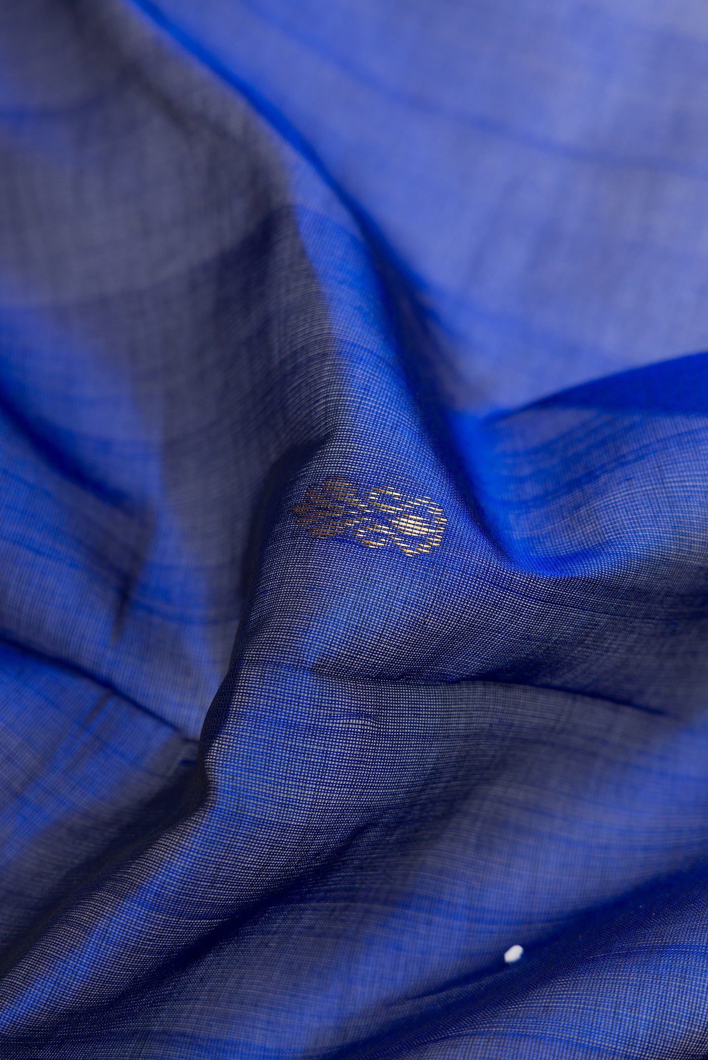 Close up of Royal Blue Silk Cotton Saree with Zari Butta on the body and Zari Border.  displaying folds