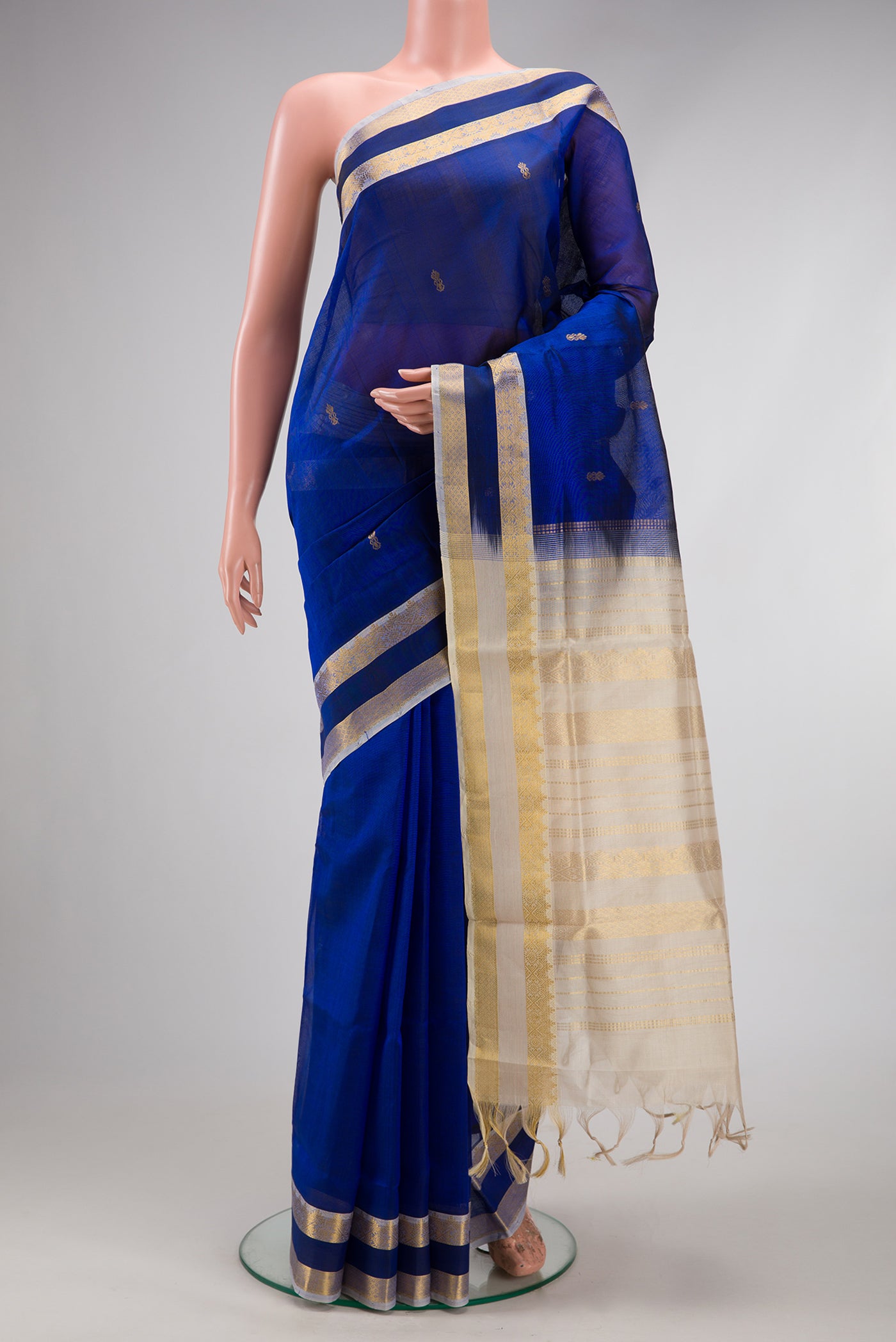 Royal Blue Silk Cotton Saree with Zari Butta on the body and Zari Border.  displayed on a mannequin