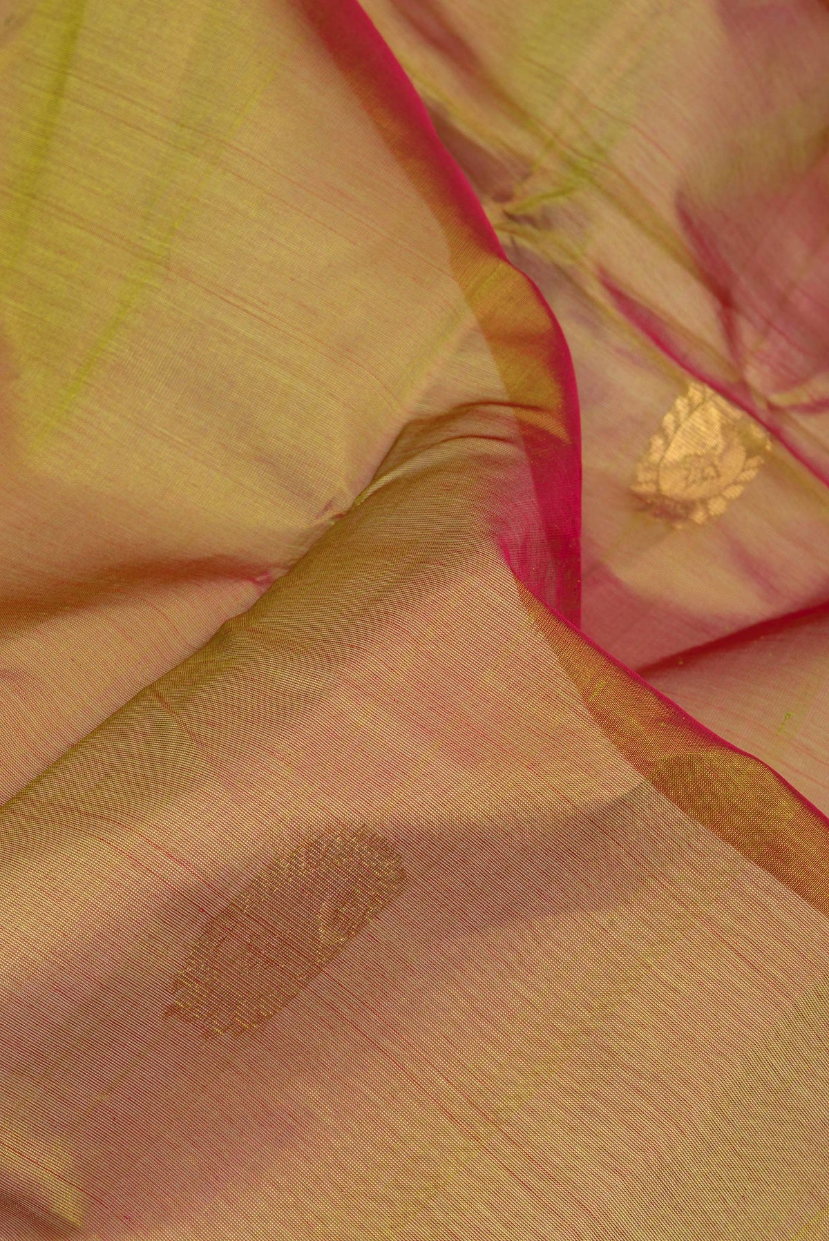 Close up of Mehandi Green Dual Tone Silk Cotton Saree with Zari Butta on the body and Zari Border.  displaying folds