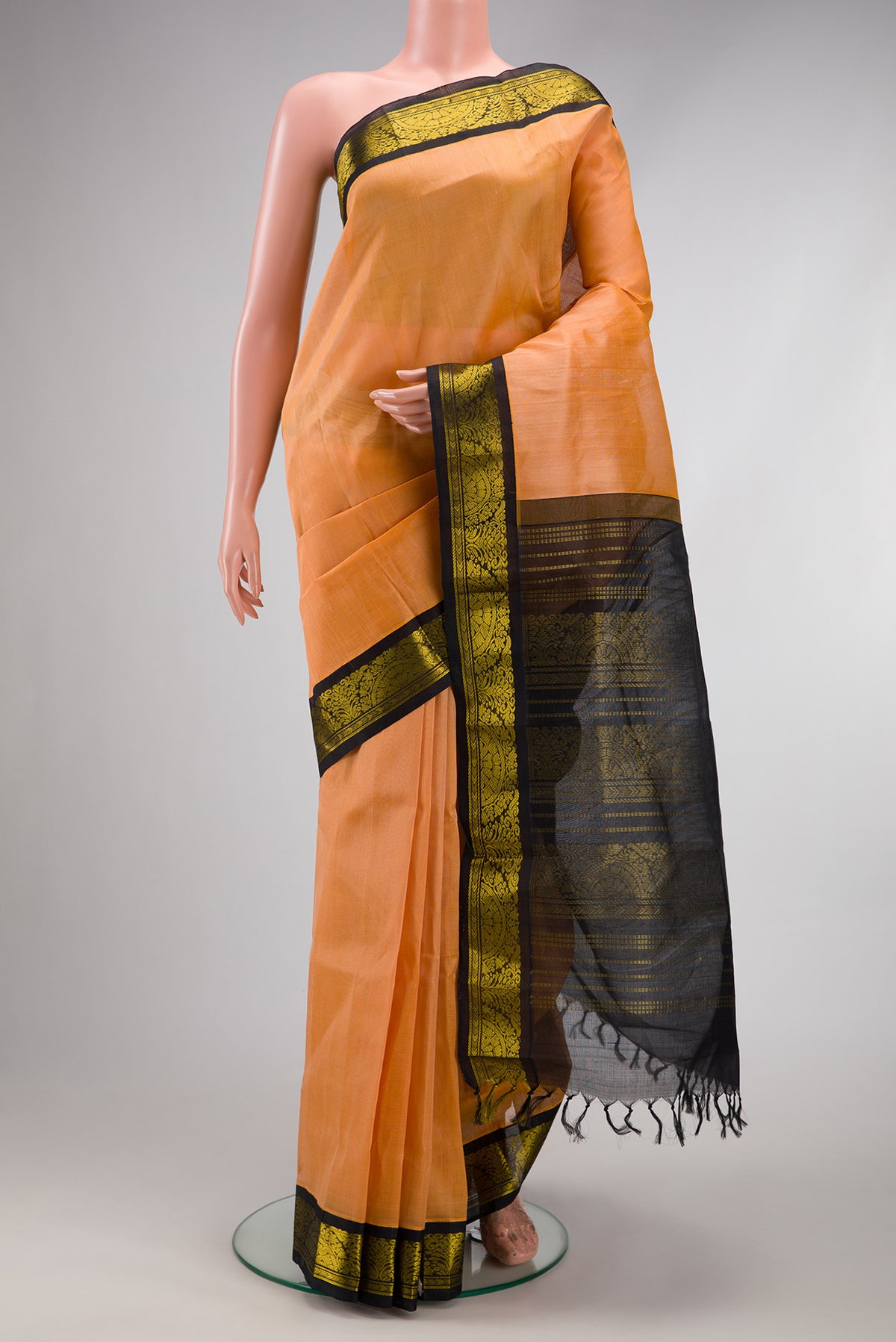 Peach Silk Cotton Saree with Plain Body and Zari Border.  displayed on a mannequin