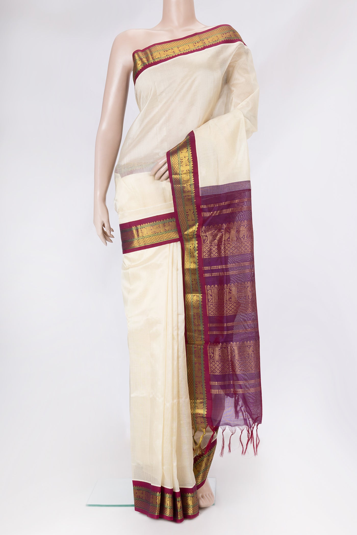Off White Silk Cotton Saree with Plain Body and Zari Border.  displayed on a mannequin